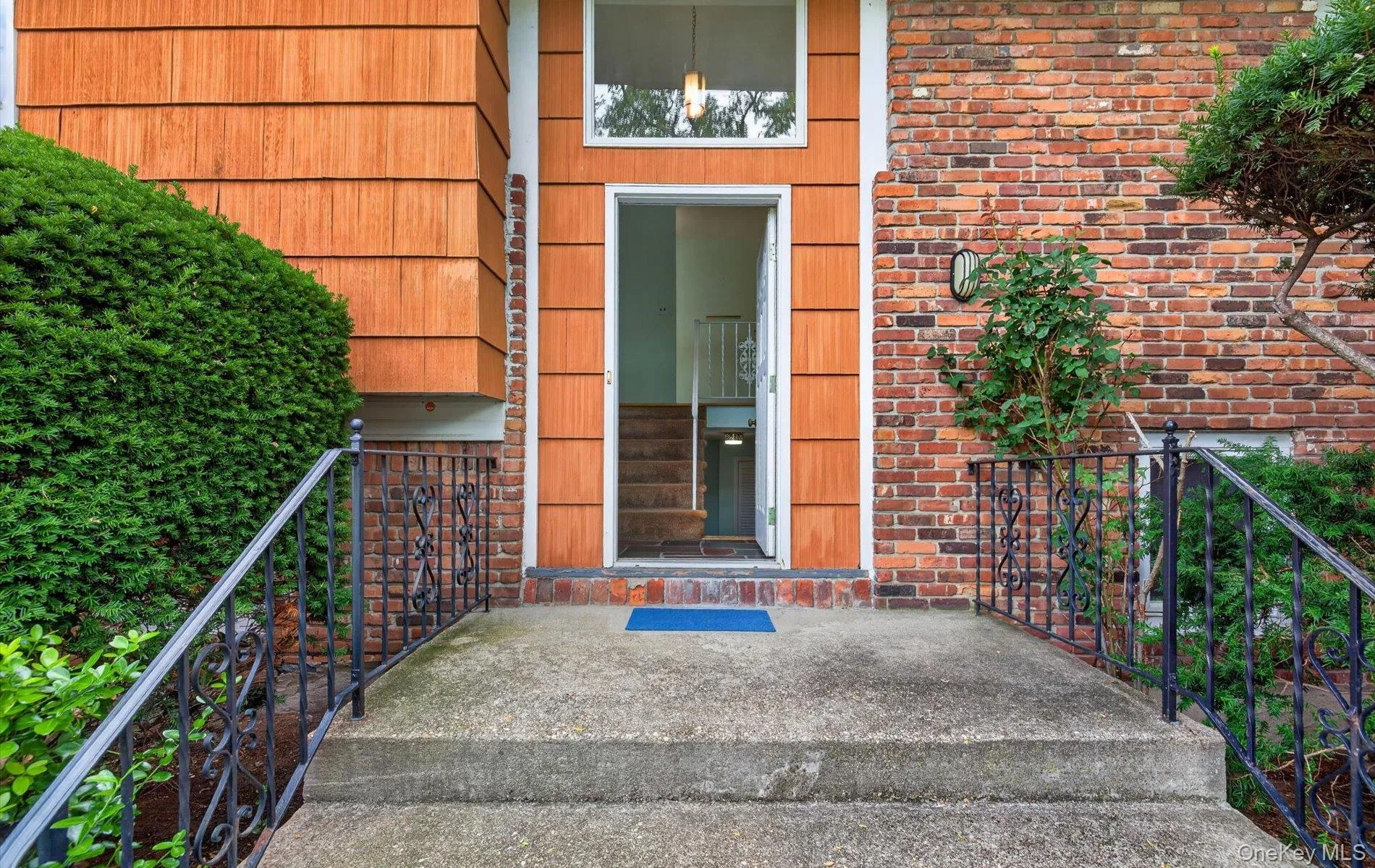 Exterior featuring wood-shingle siding and brickwork Exterior featuring wood-shingle siding and brickwork