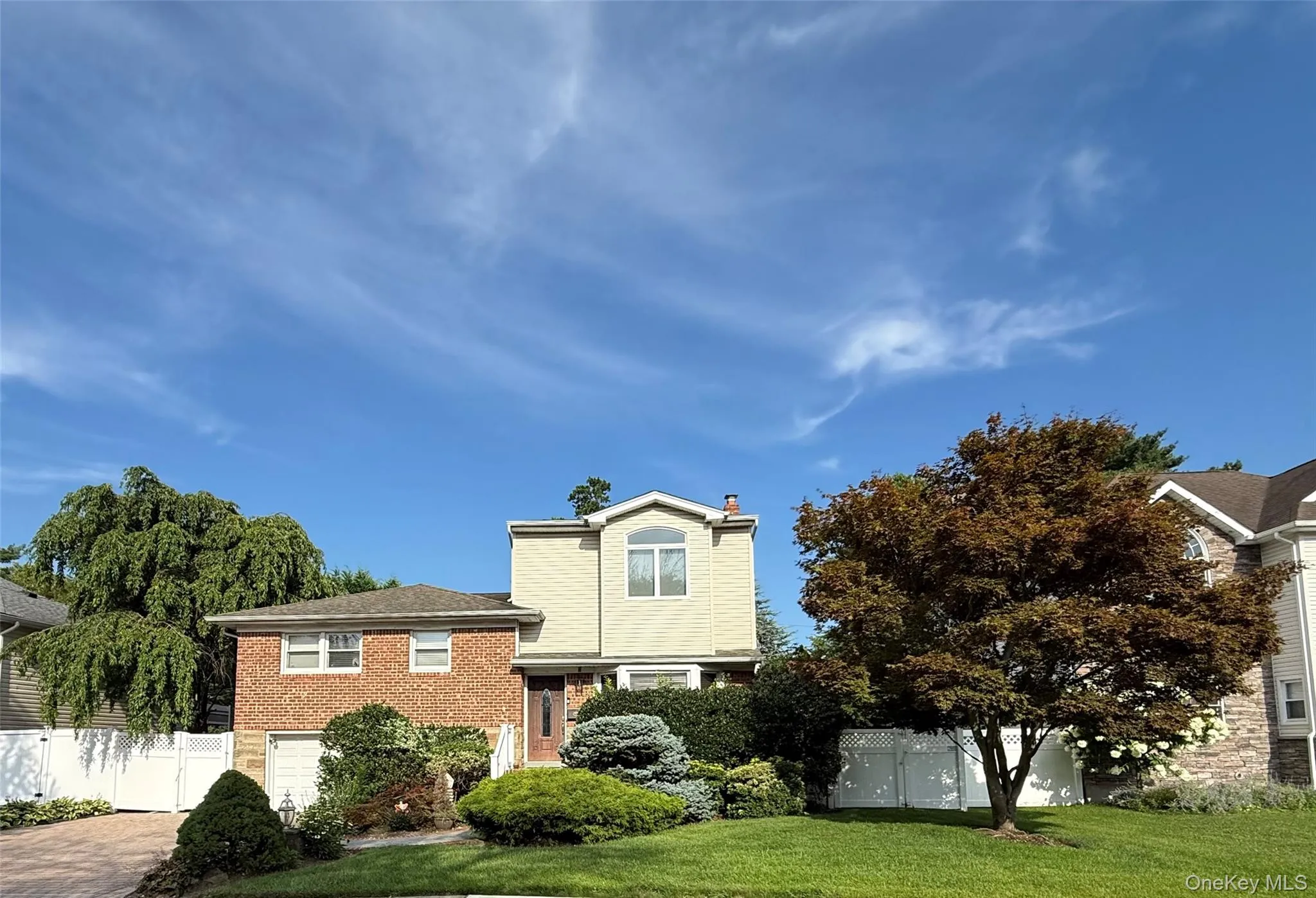 Well-maintained brick and vinyl-sided split-level, paver driveway, and manicured landscaping. Move-in ready with great curb appeal Well-maintained brick and vinyl-sided split-level, paver driveway, and manicured landscaping. Move-in ready with great curb appeal