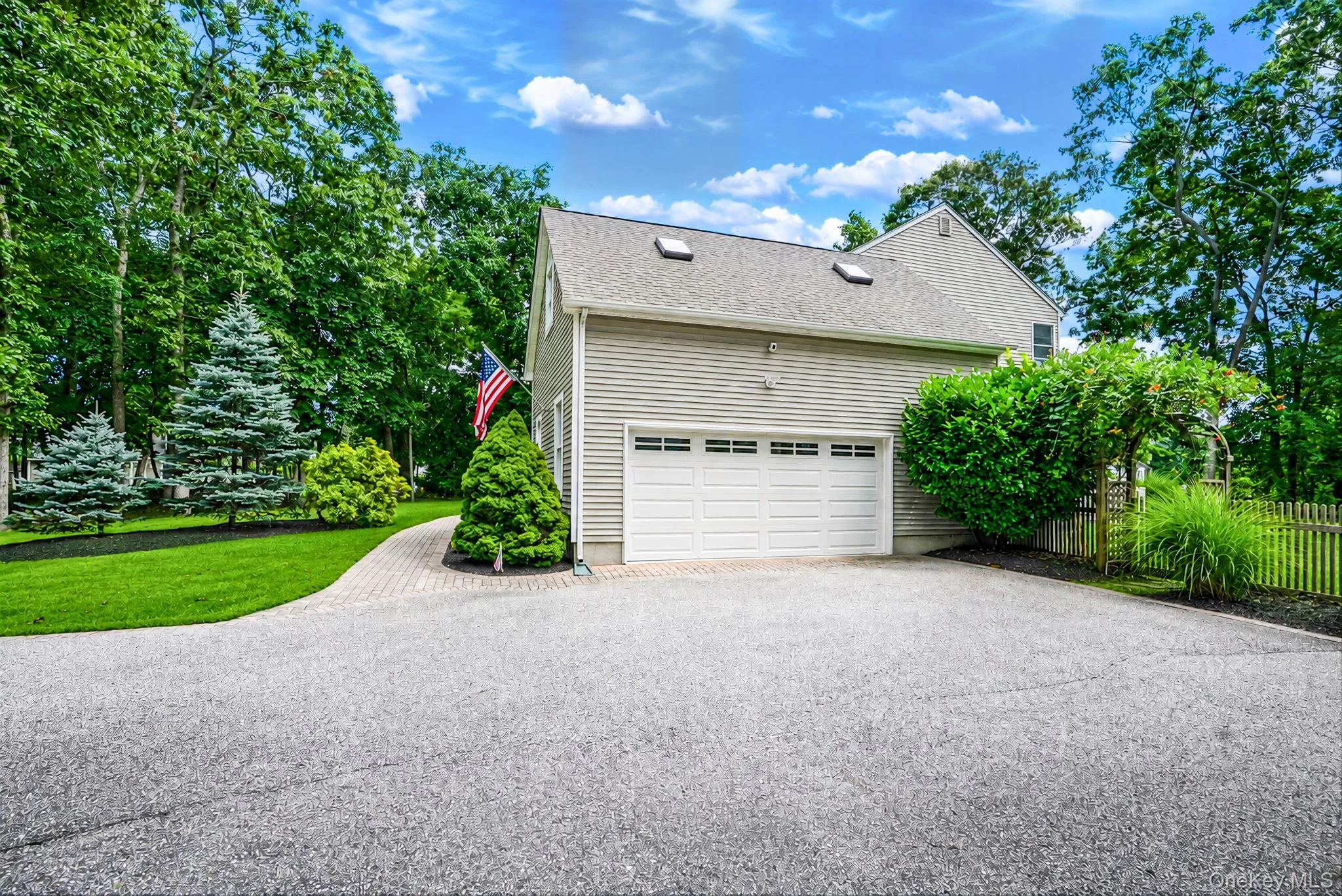 Side view of home with driveway and two car garage. Side view of home with driveway and two car garage.