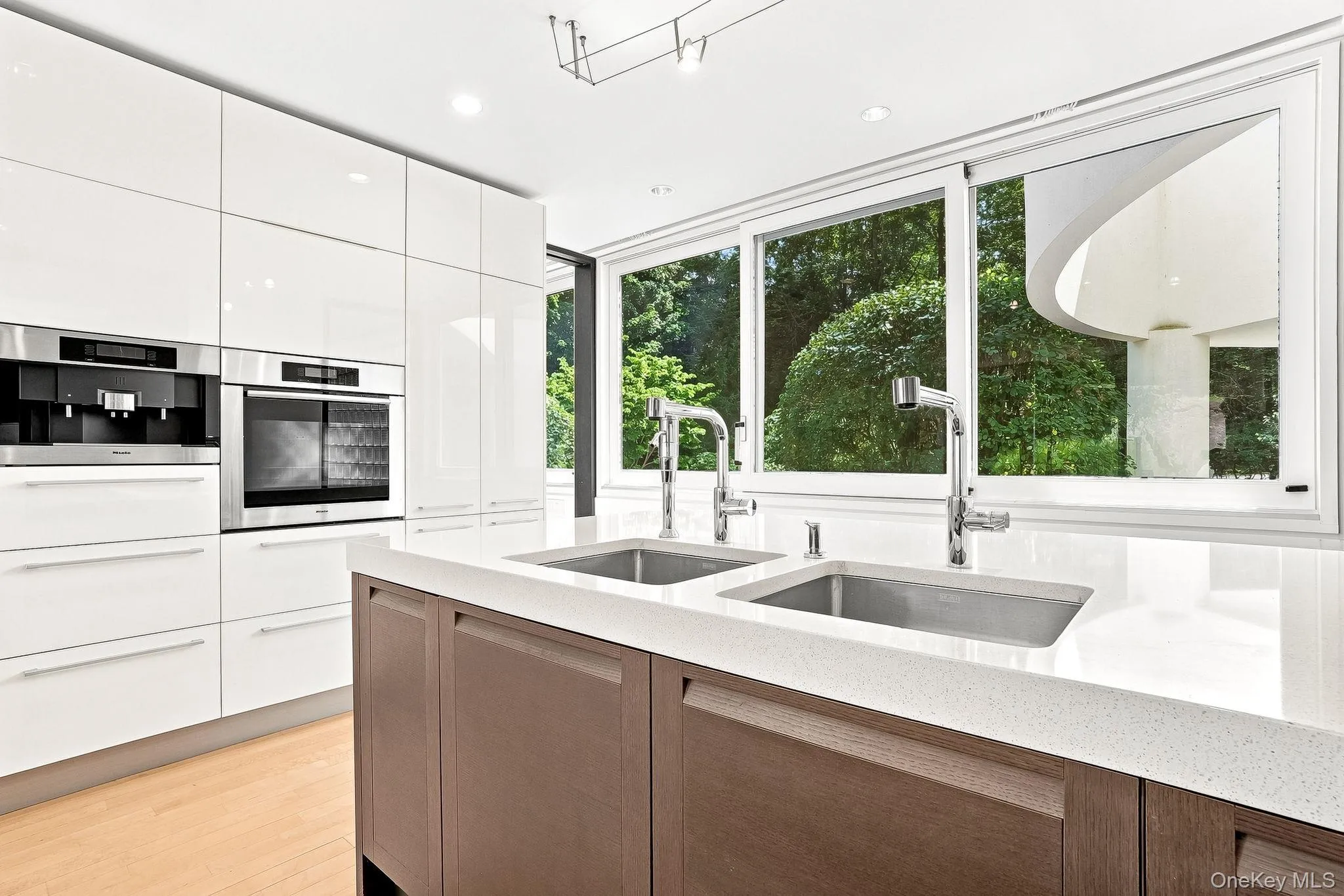 Double sink and views into front yard. Double sink and views into front yard.