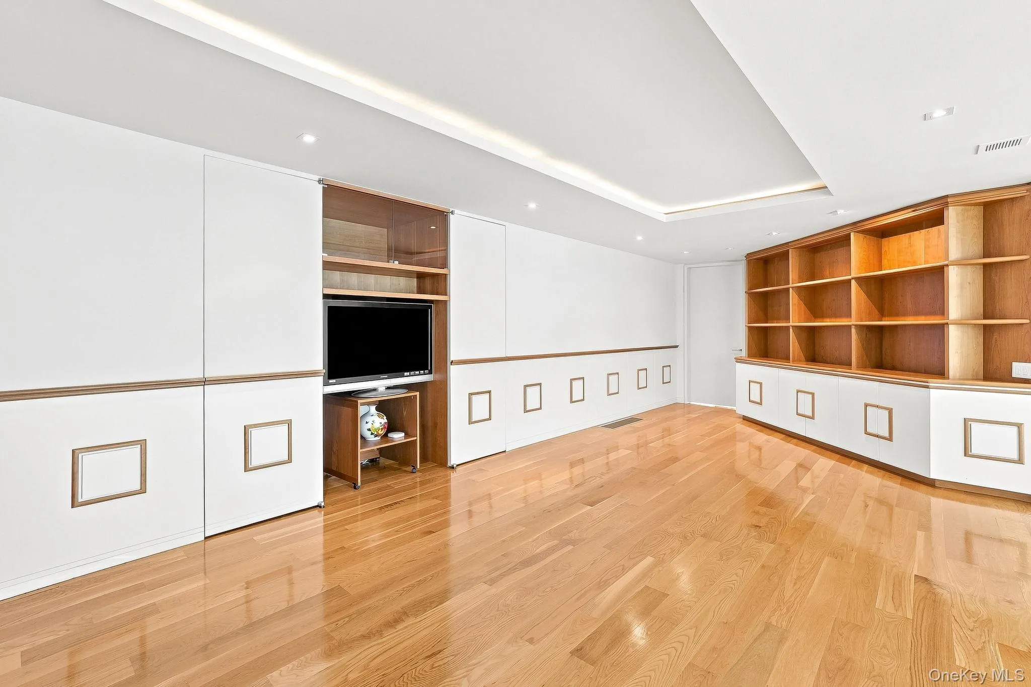Landing area with built-in bookshelves and flat screen TV on second floor Landing area with built-in bookshelves and flat screen TV on second floor