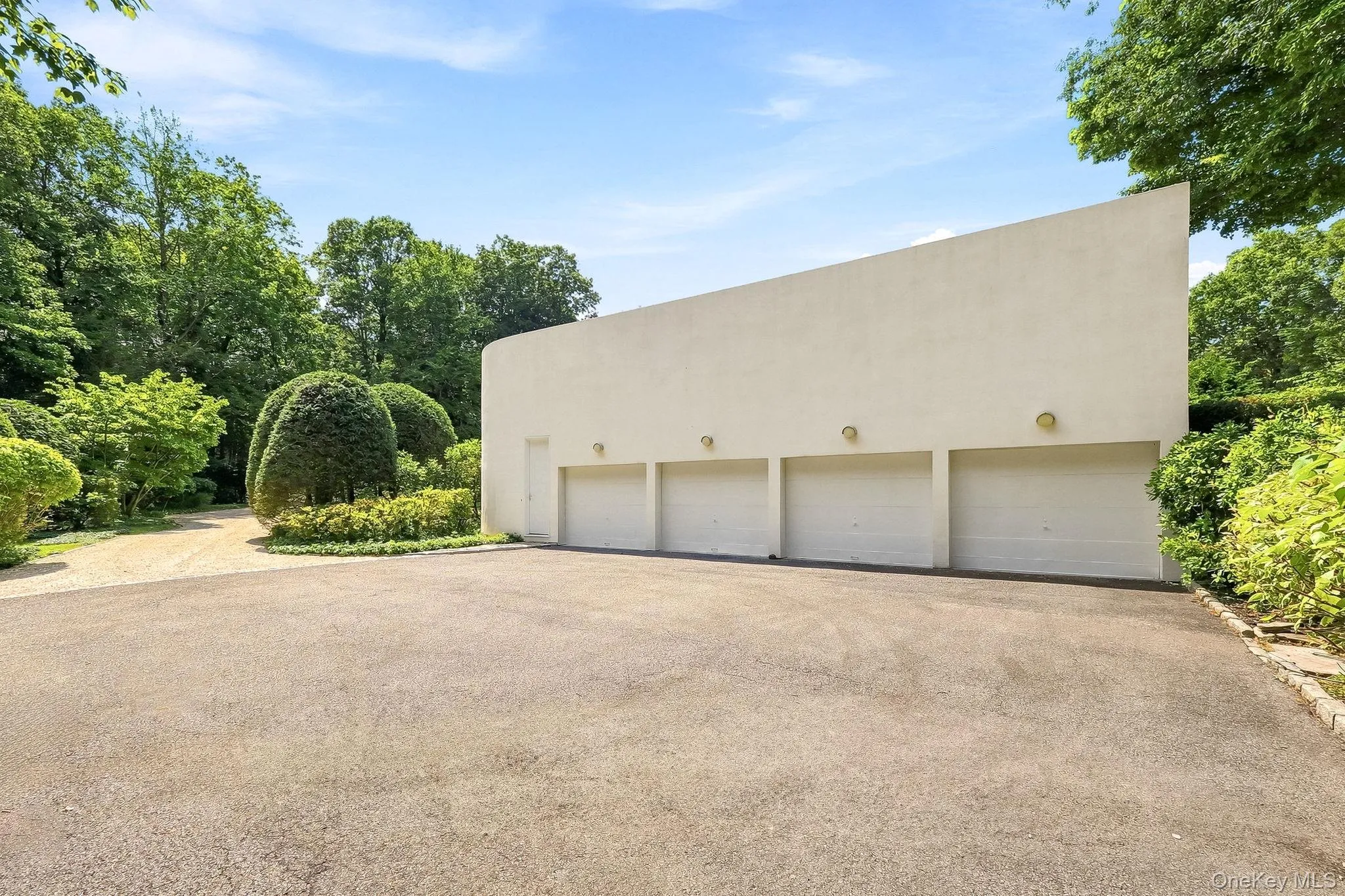 Expansive four-car garage with ample parking within the beautifully landscaped grounds. Expansive four-car garage with ample parking within the beautifully landscaped grounds.