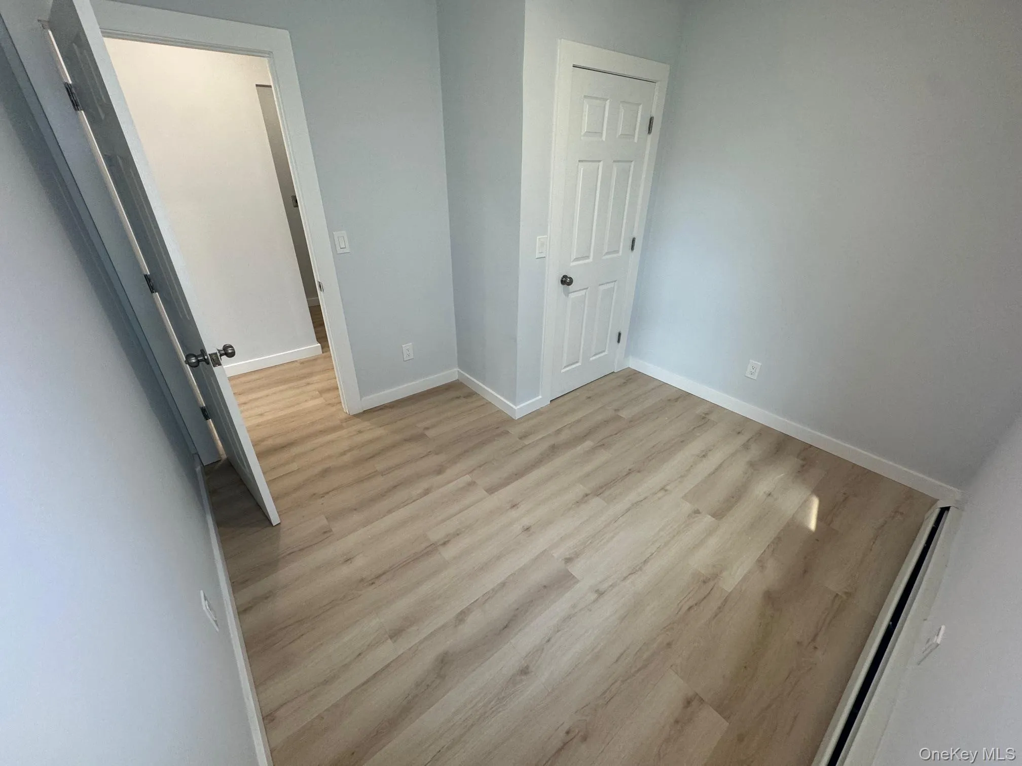 Unfurnished bedroom featuring baseboards and light wood-style floors Unfurnished bedroom featuring baseboards and light wood-style floors