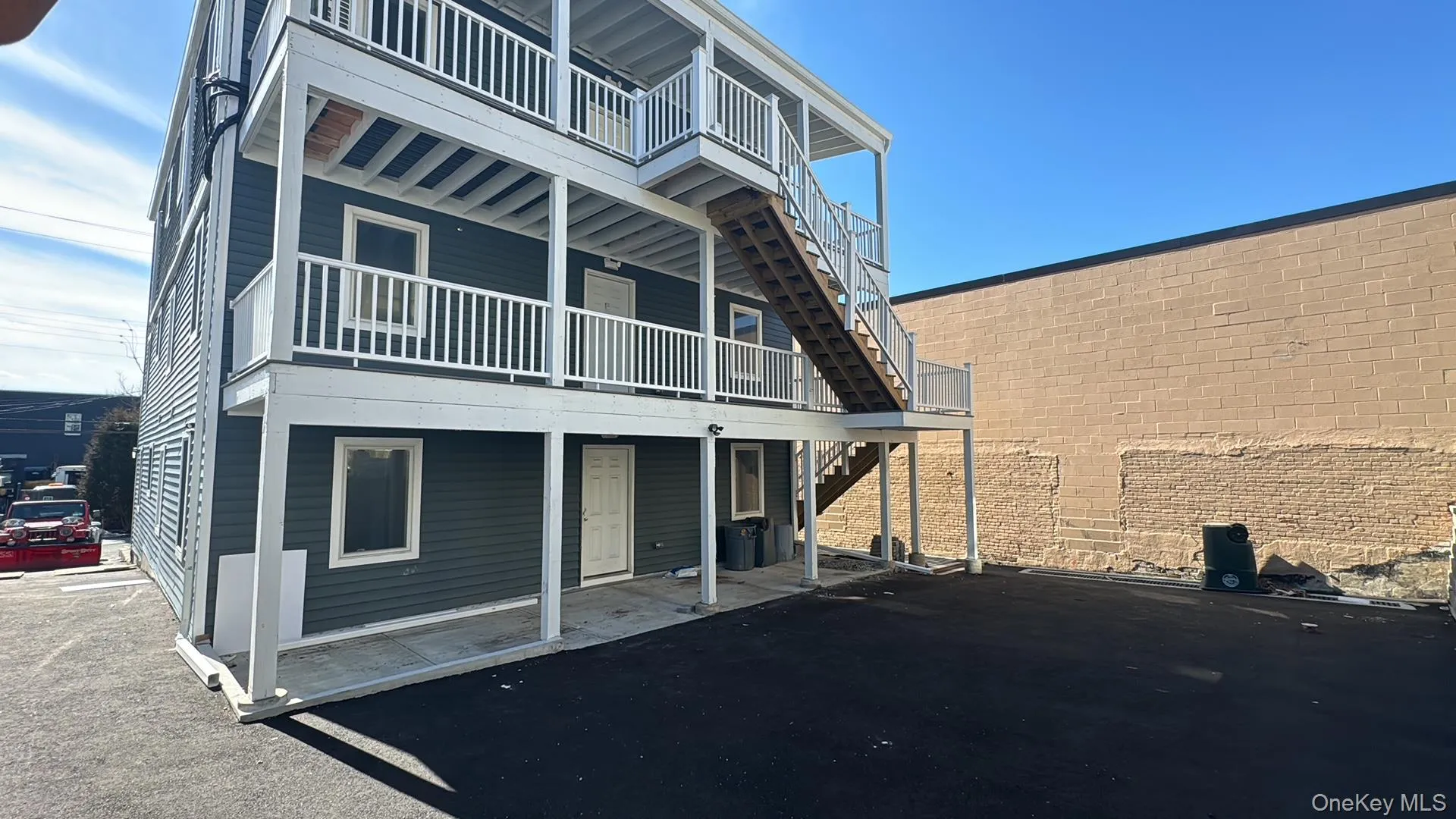 Back of house with stairs and a balcony Back of house with stairs and a balcony