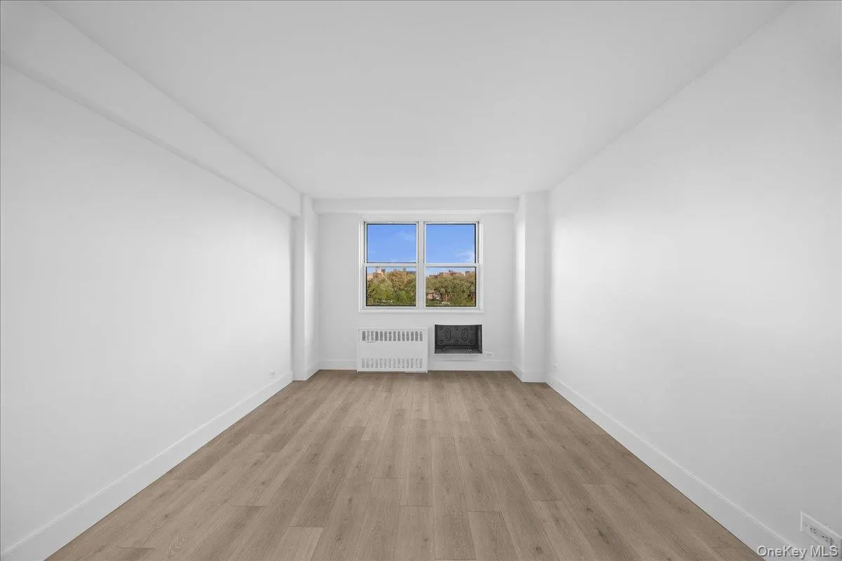 Bright interior space featuring a light vinyl, white walls, and a white interior door with dark hardware Bright interior space featuring a light vinyl, white walls, and a white interior door with dark hardware