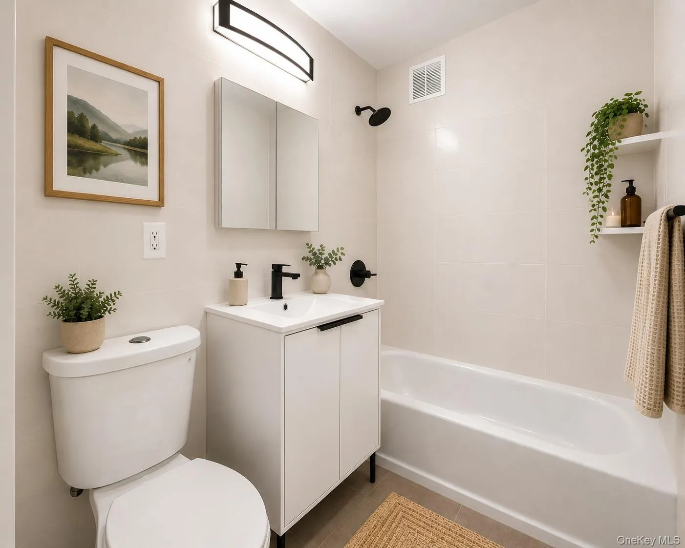 White vanity with integrated sink, black fixtures, and a white bathtub with tiled surround White vanity with integrated sink, black fixtures, and a white bathtub with tiled surround