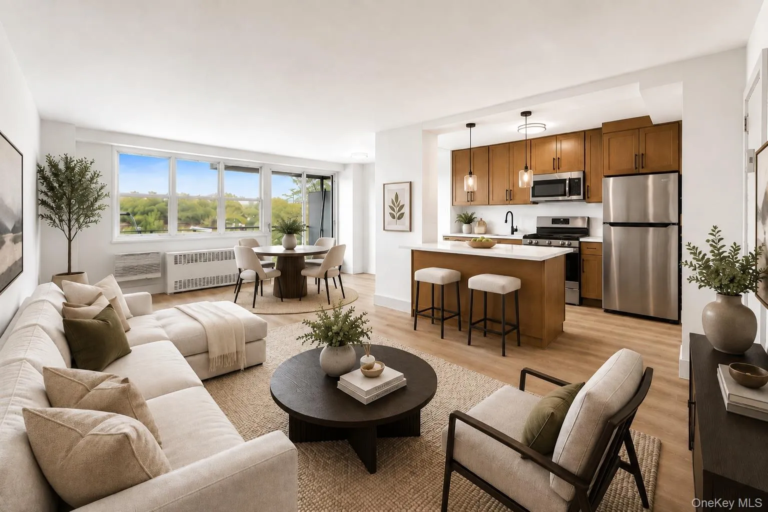 Open-concept living space featuring vinyl flooring, a full kitchen with stainless steel appliances and pendant lighting, and a dining area with expansive windows Open-concept living space featuring vinyl flooring, a full kitchen with stainless steel appliances and pendant lighting, and a dining area with expansive windows
