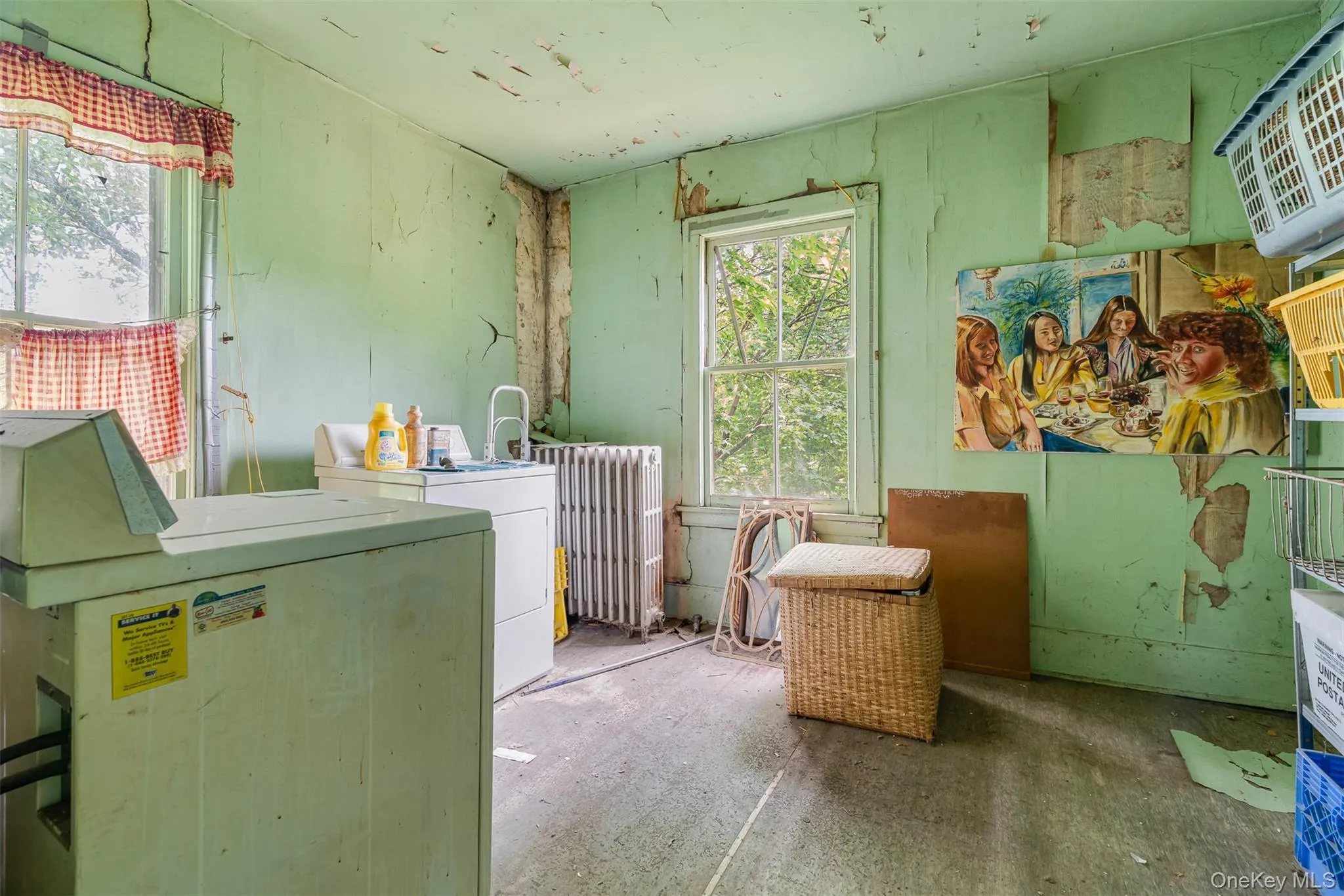Laundry room with radiator and washing machine and clothes dryer Laundry room with radiator and washing machine and clothes dryer