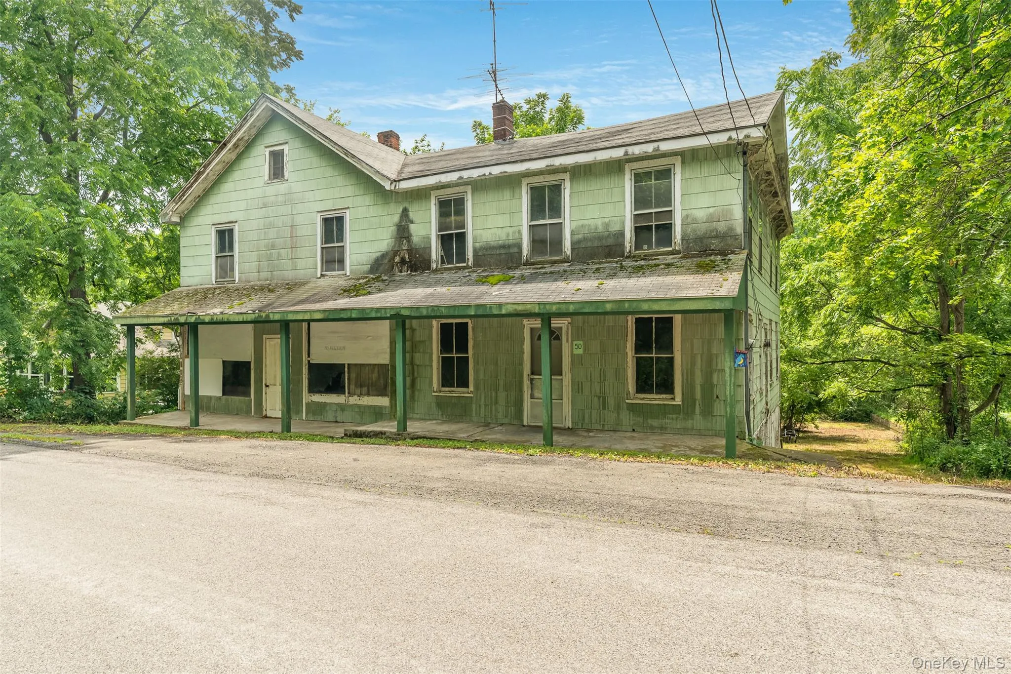 View of front of home with a chimney and covered porch View of front of home with a chimney and covered porch