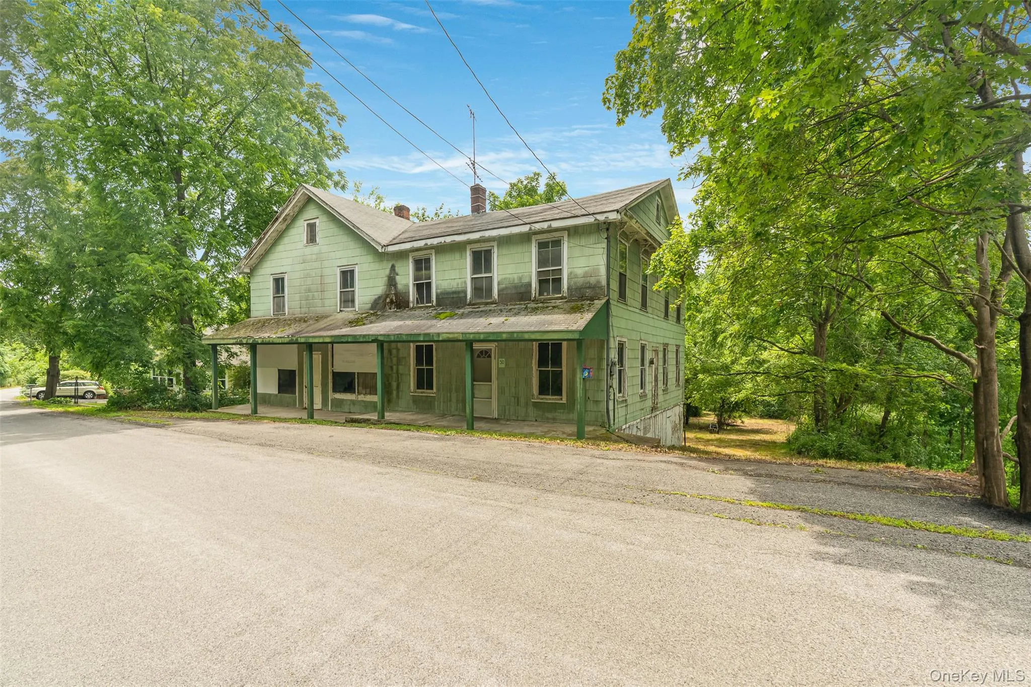 View of front of home featuring a chimney and covered porch View of front of home featuring a chimney and covered porch