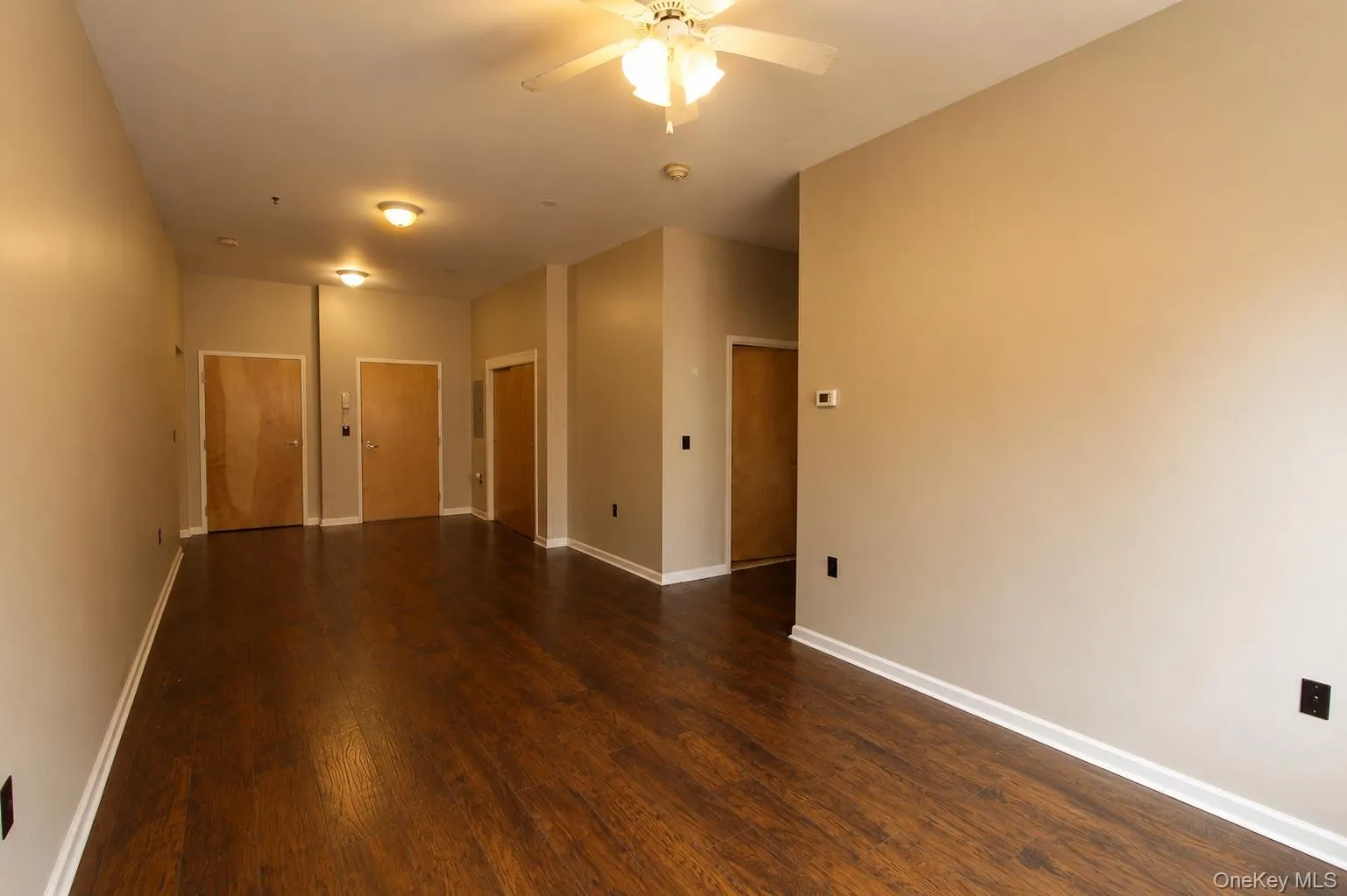 Wood-finish flooring throughout, complemented by a ceiling fan with integrated lighting Wood-finish flooring throughout, complemented by a ceiling fan with integrated lighting