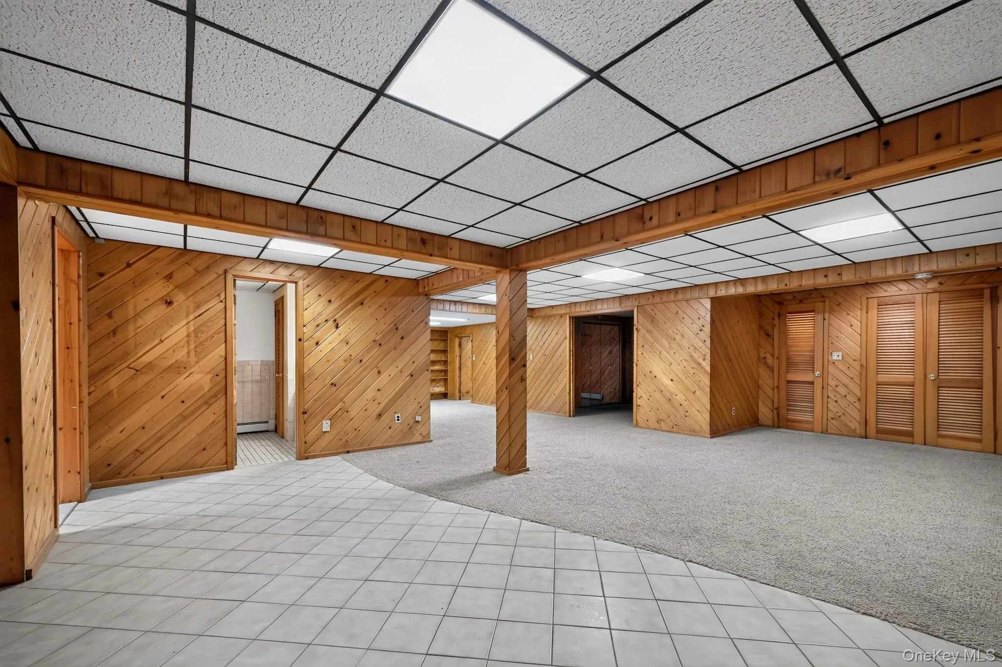 A finished lower level bonus space spanning approximately one thousand square feet, detailed with real wood wall planking, a full summer kitchen, and multiple storage rooms A finished lower level bonus space spanning approximately one thousand square feet, detailed with real wood wall planking, a full summer kitchen, and multiple storage rooms