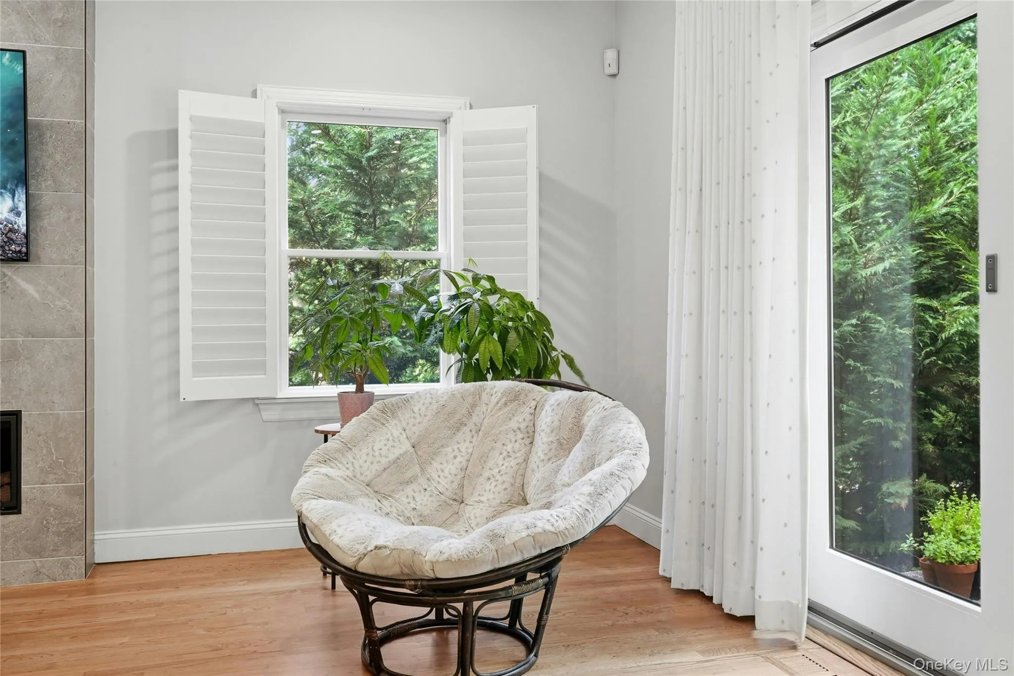 Delightful reading corner near patio sliders, custom plantation shutters Delightful reading corner near patio sliders, custom plantation shutters