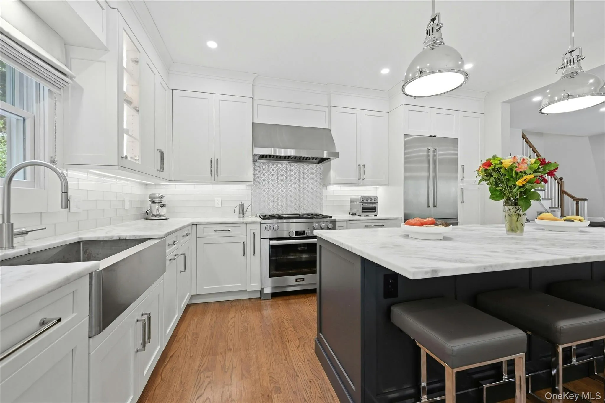 Leathered quartzite counters and custom Maple cabinets with polished nickel handles Leathered quartzite counters and custom Maple cabinets with polished nickel handles