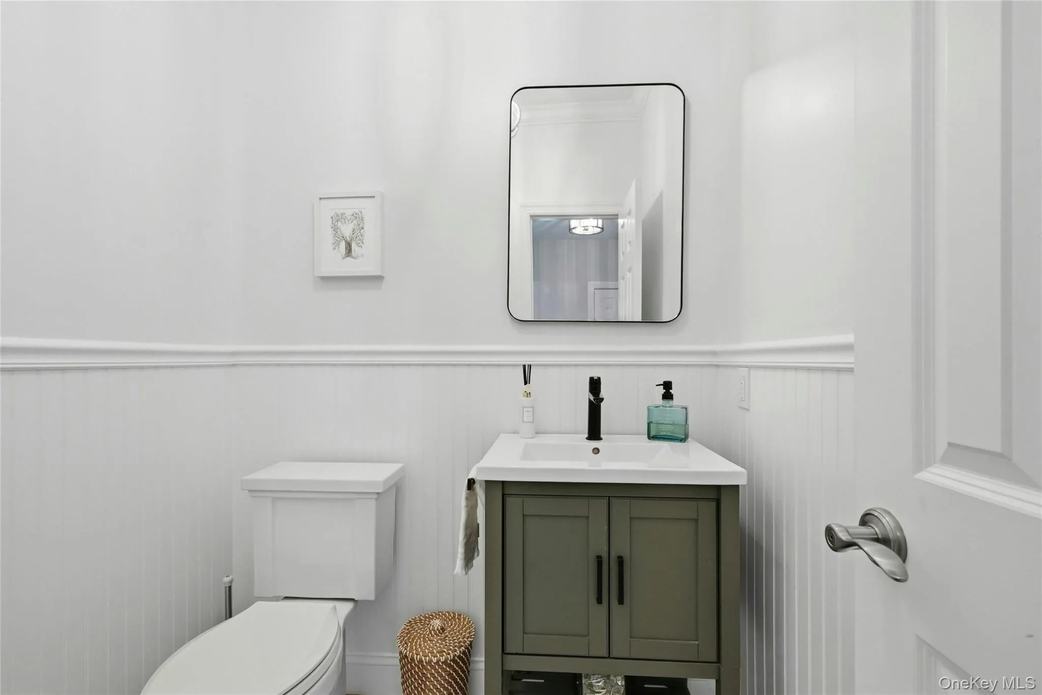 Main floor half bath with marble tile Main floor half bath with marble tile