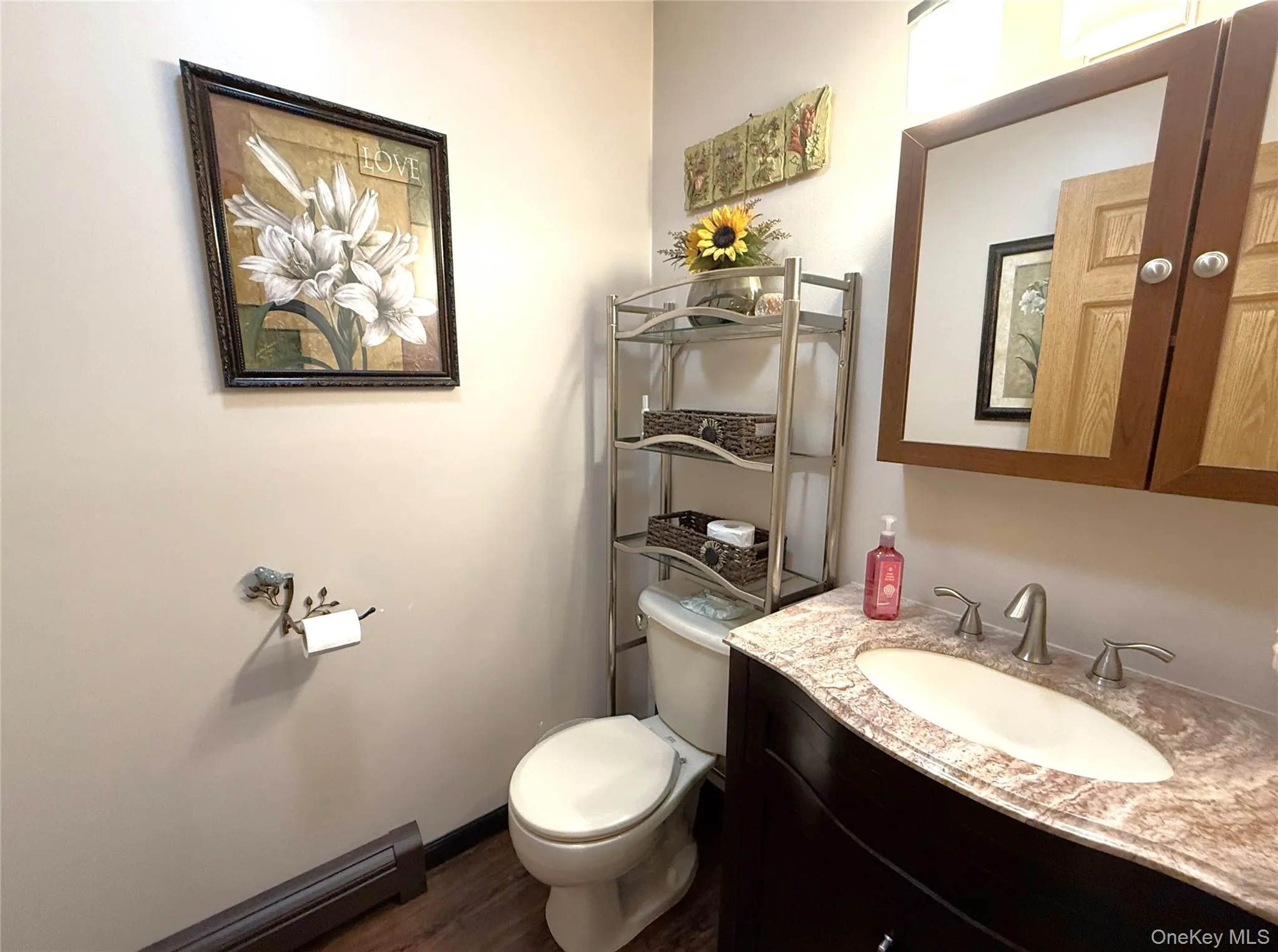 1st floor half bath. Pretty vanity has a granite top. 1st floor half bath. Pretty vanity has a granite top.