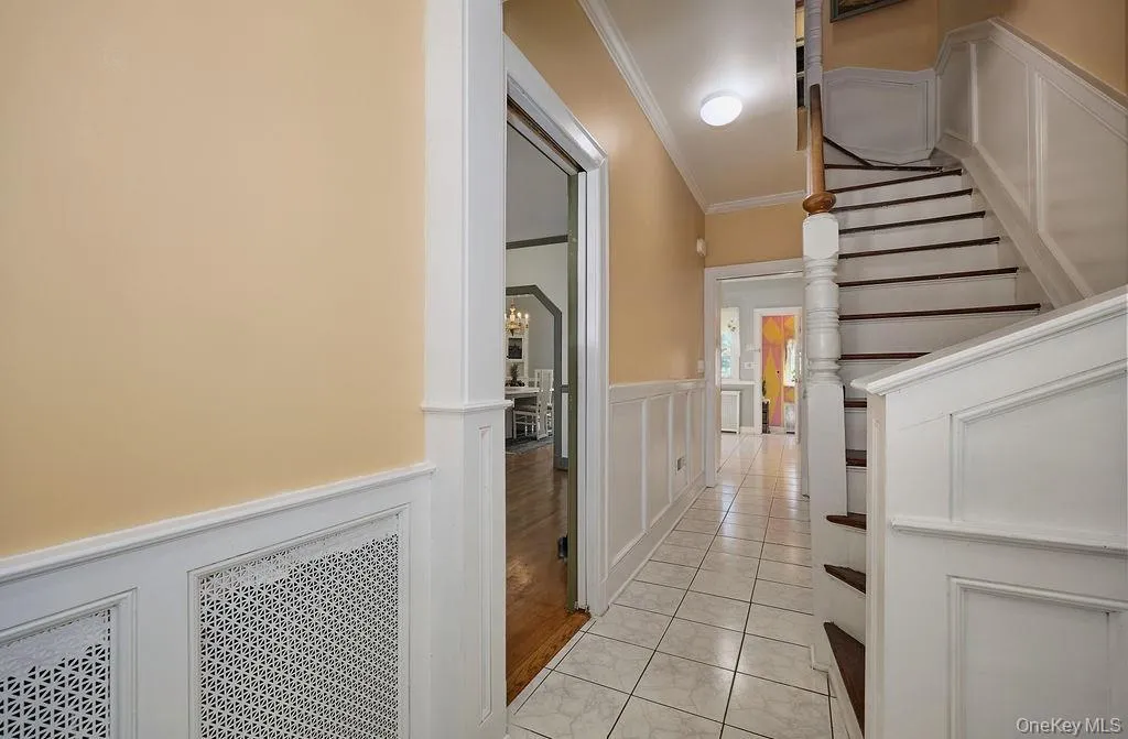 Entryway with tiled flooring and wainscoting. Entryway with tiled flooring and wainscoting.