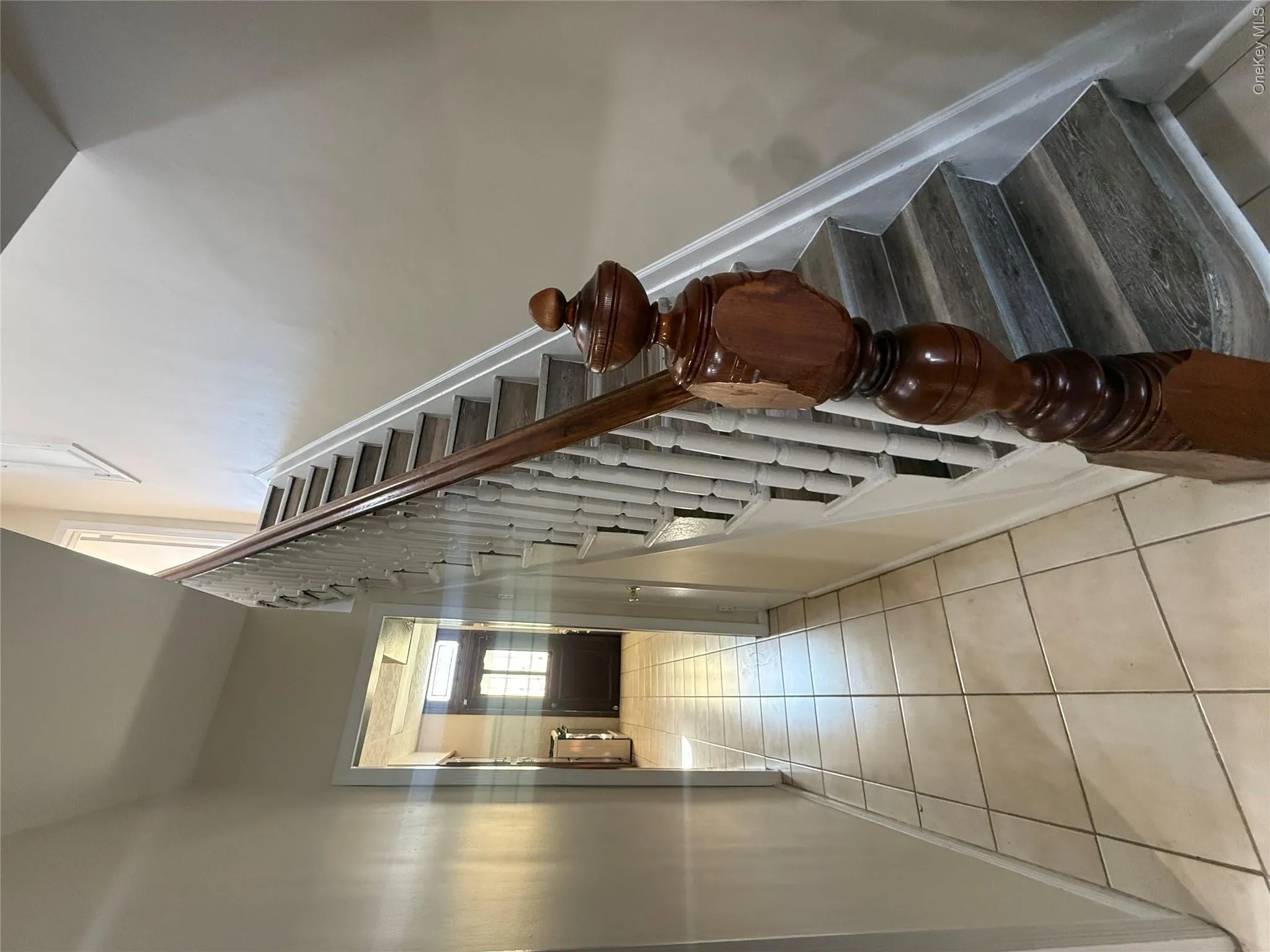 Stairs featuring tile patterned floors Stairs featuring tile patterned floors