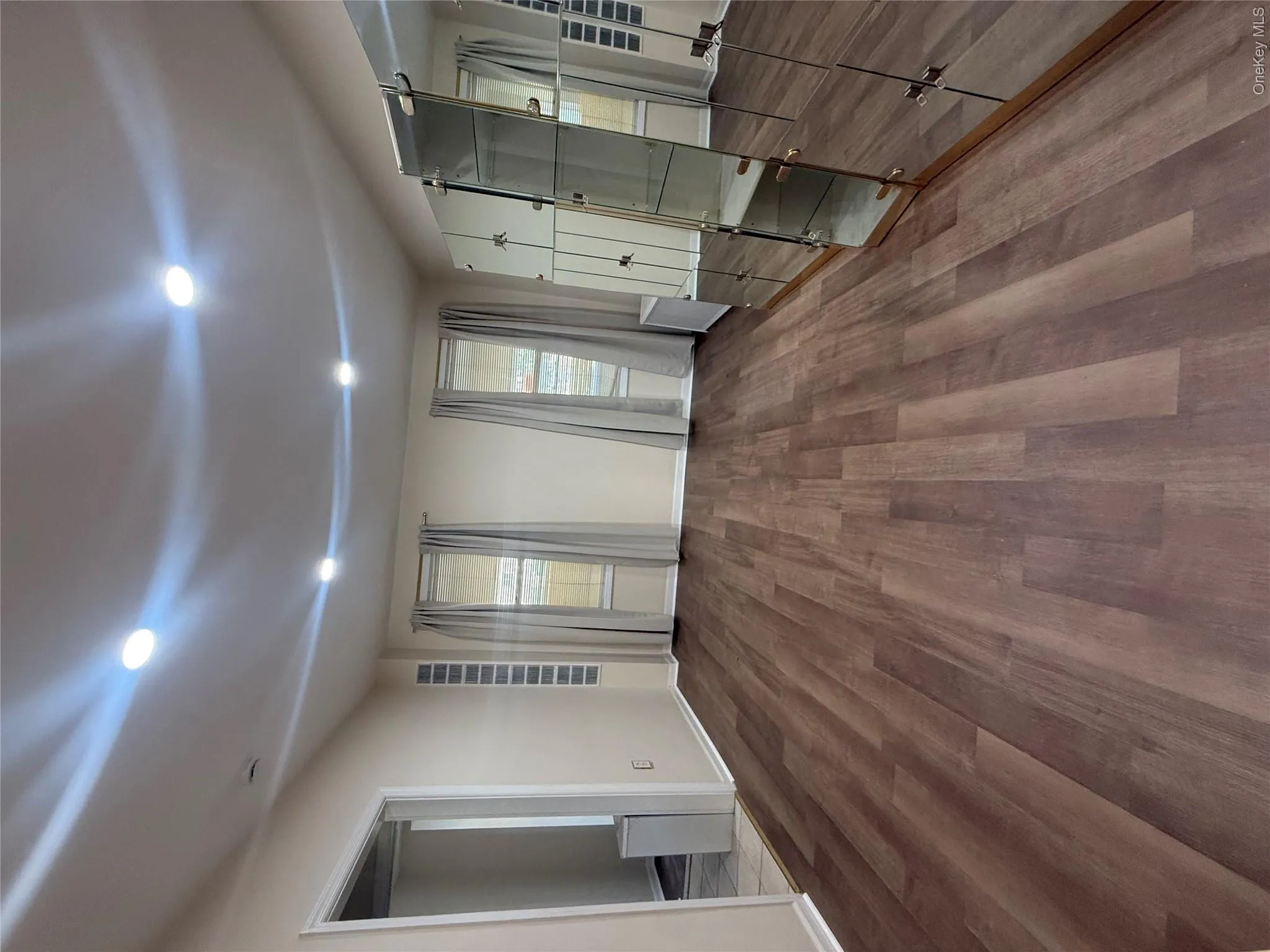 Unfurnished bedroom featuring wood finished floors and recessed lighting Unfurnished bedroom featuring wood finished floors and recessed lighting
