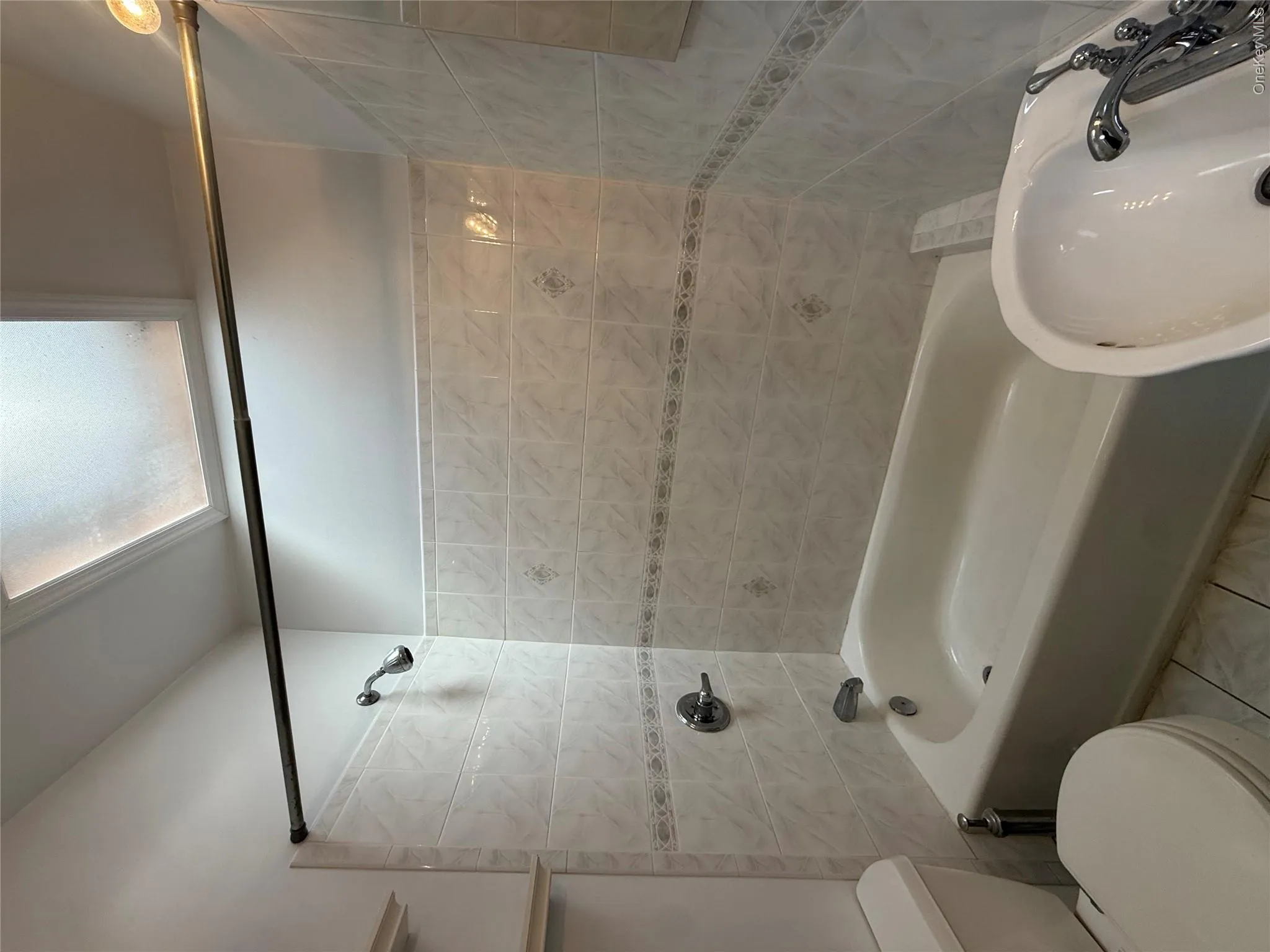 Bathroom featuring bathing tub / shower combination and tile patterned flooring Bathroom featuring bathing tub / shower combination and tile patterned flooring