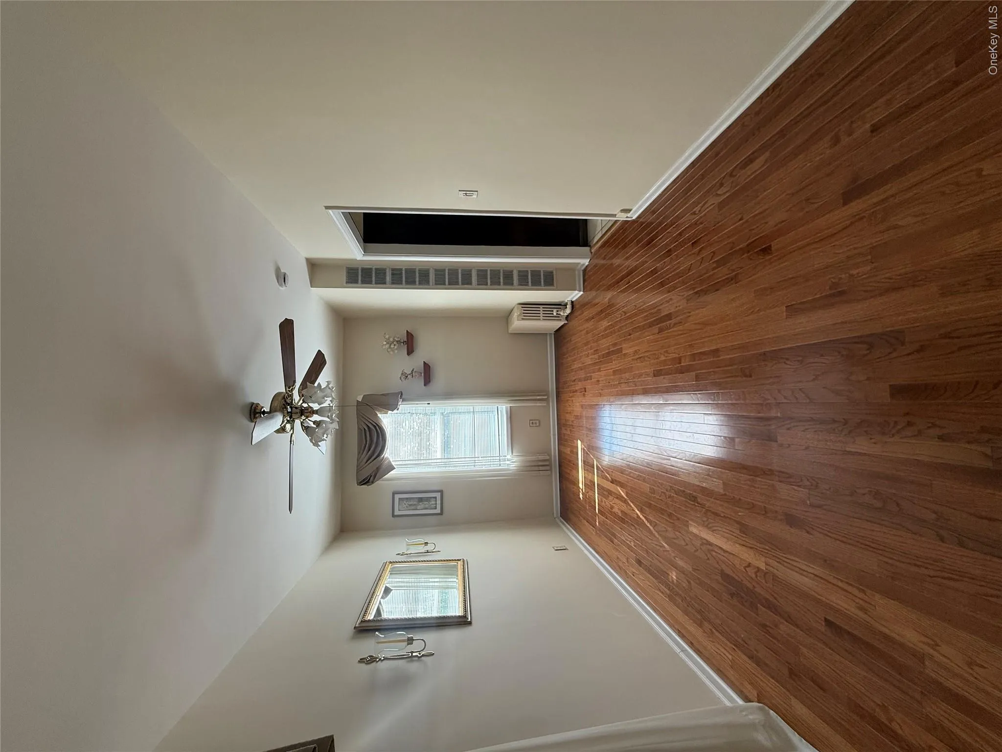 Unfurnished living room featuring dark wood-type flooring, radiator, and ceiling fan Unfurnished living room featuring dark wood-type flooring, radiator, and ceiling fan
