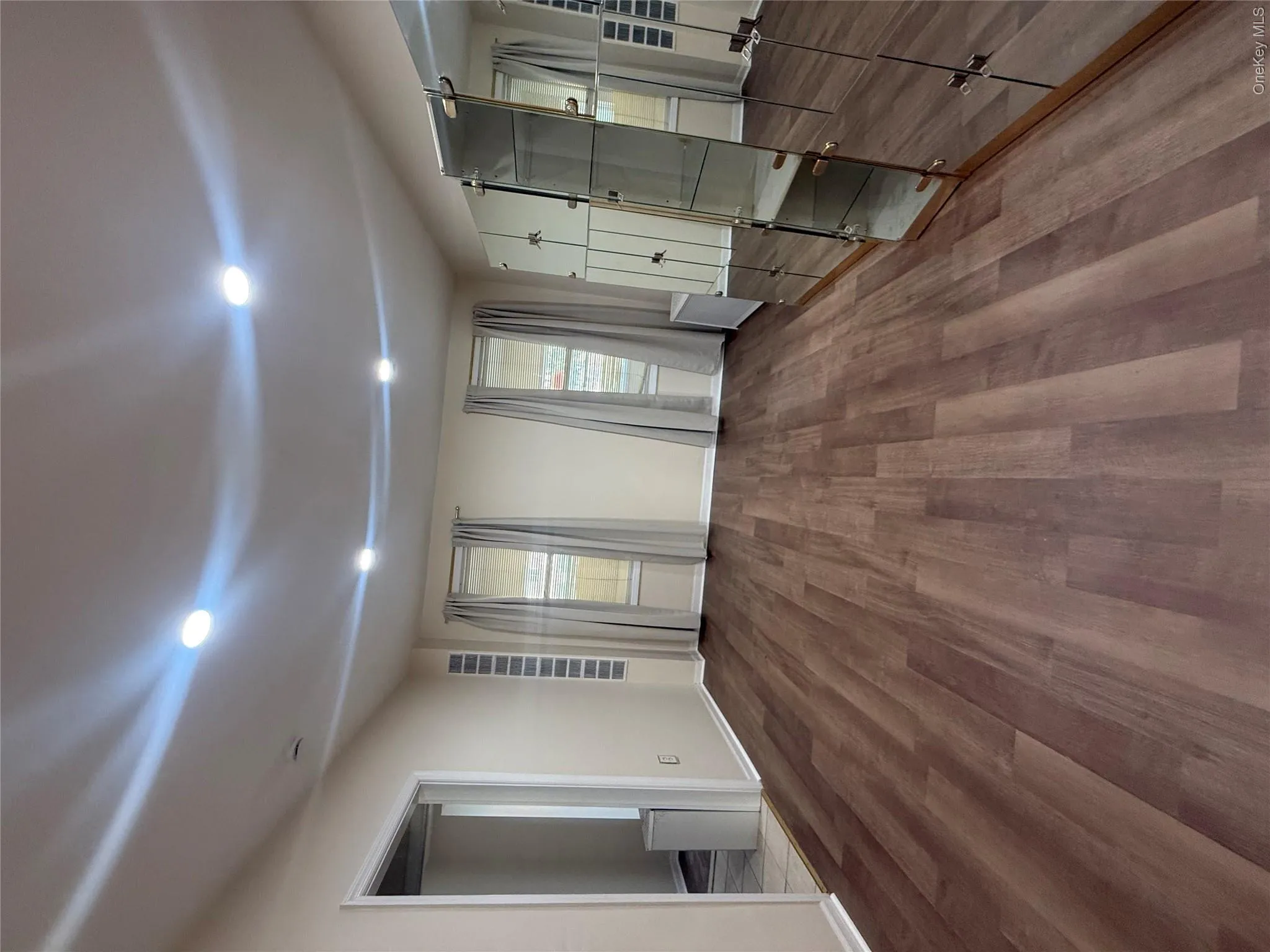 Unfurnished bedroom featuring wood finished floors and recessed lighting Unfurnished bedroom featuring wood finished floors and recessed lighting
