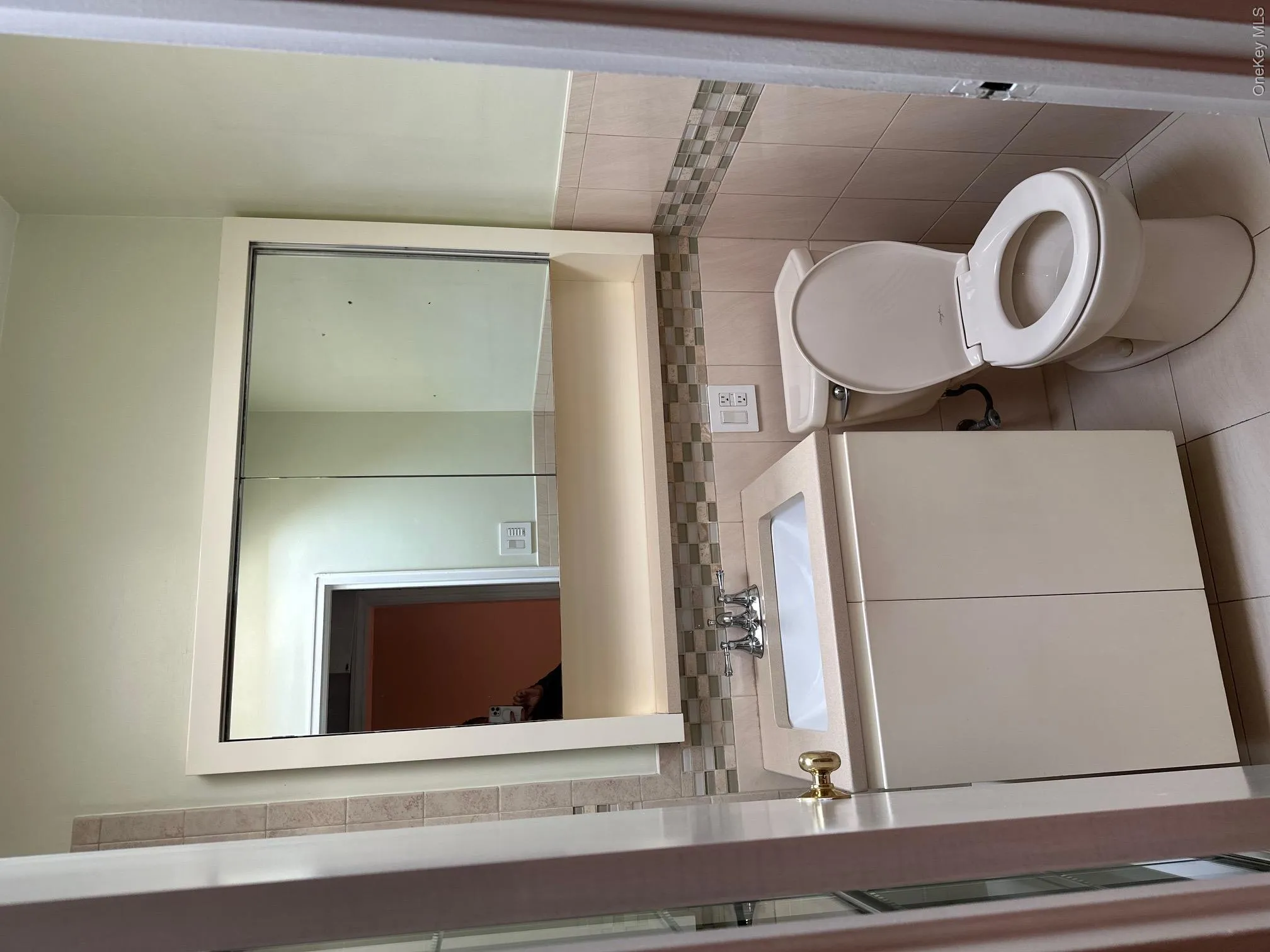 White vanity with an integrated sink, polished chrome faucet, and mirrored medicine cabinet White vanity with an integrated sink, polished chrome faucet, and mirrored medicine cabinet
