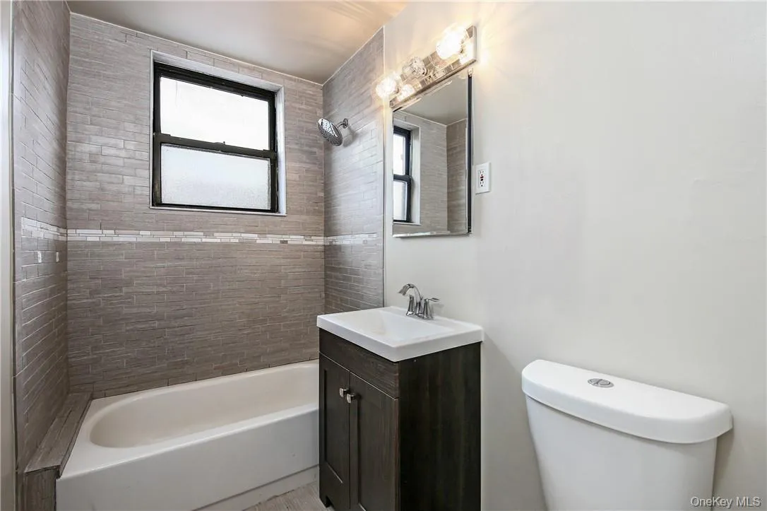 Updated bathroom with a tub Updated bathroom with a tub