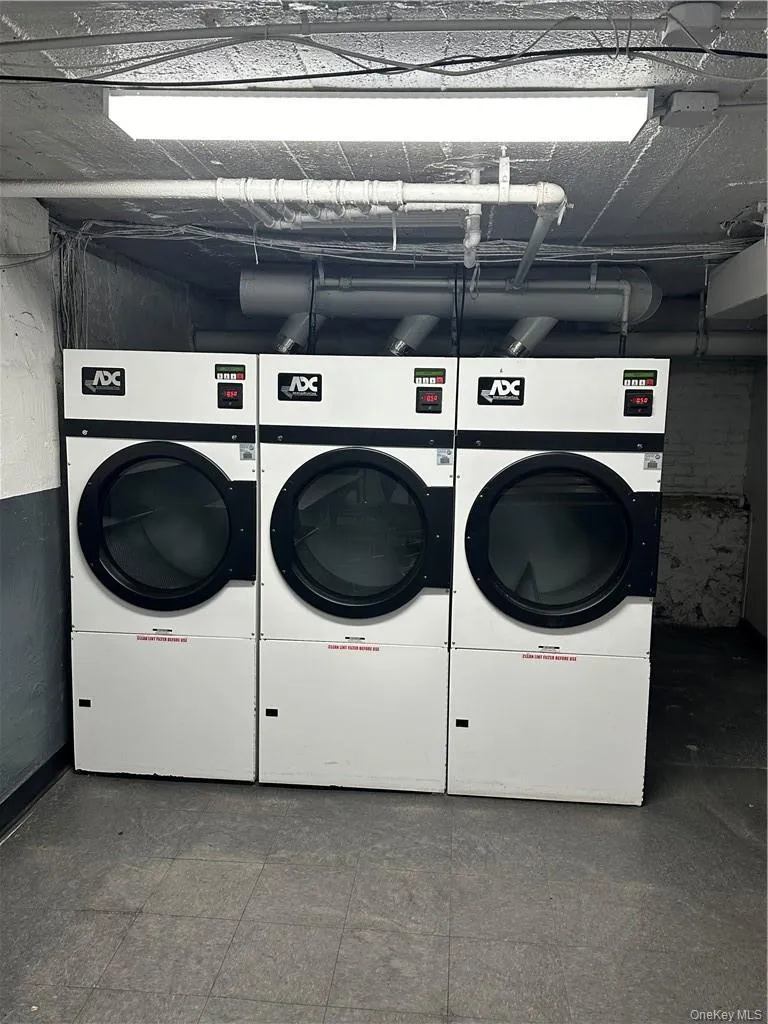 Laundry area featuring tile floors and washer / clothes dryer Laundry area featuring tile floors and washer / clothes dryer
