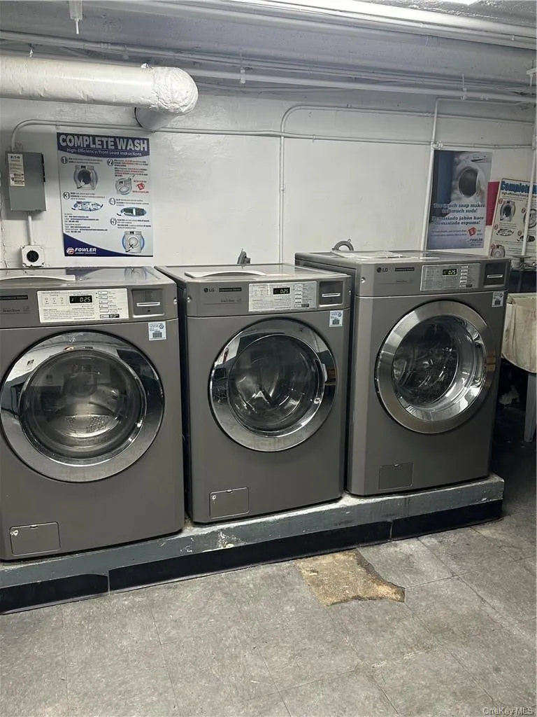 Washroom with tile floors and washing machine and dryer Washroom with tile floors and washing machine and dryer