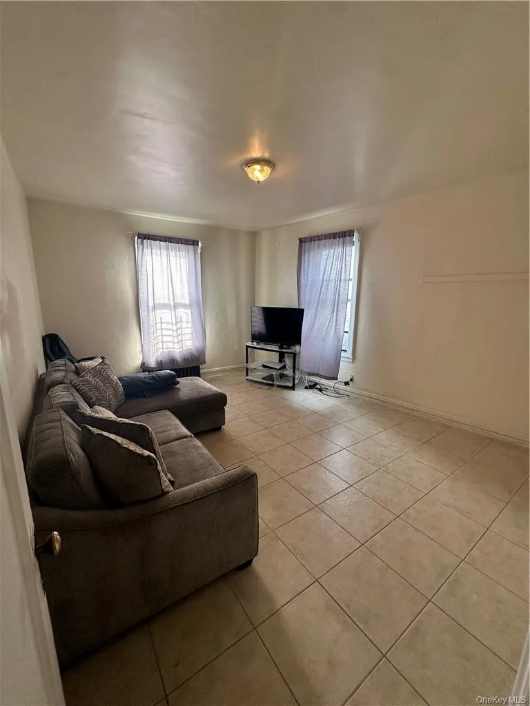 Living room featuring light tile floors Living room featuring light tile floors