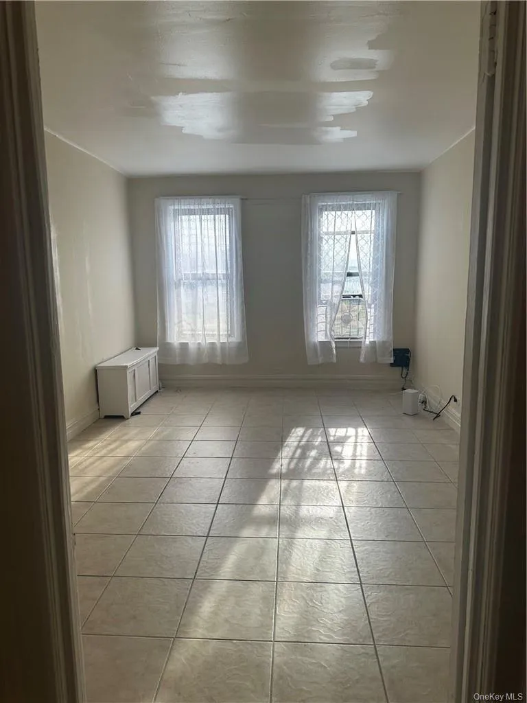 Bedroom featuring light tile floors Bedroom featuring light tile floors