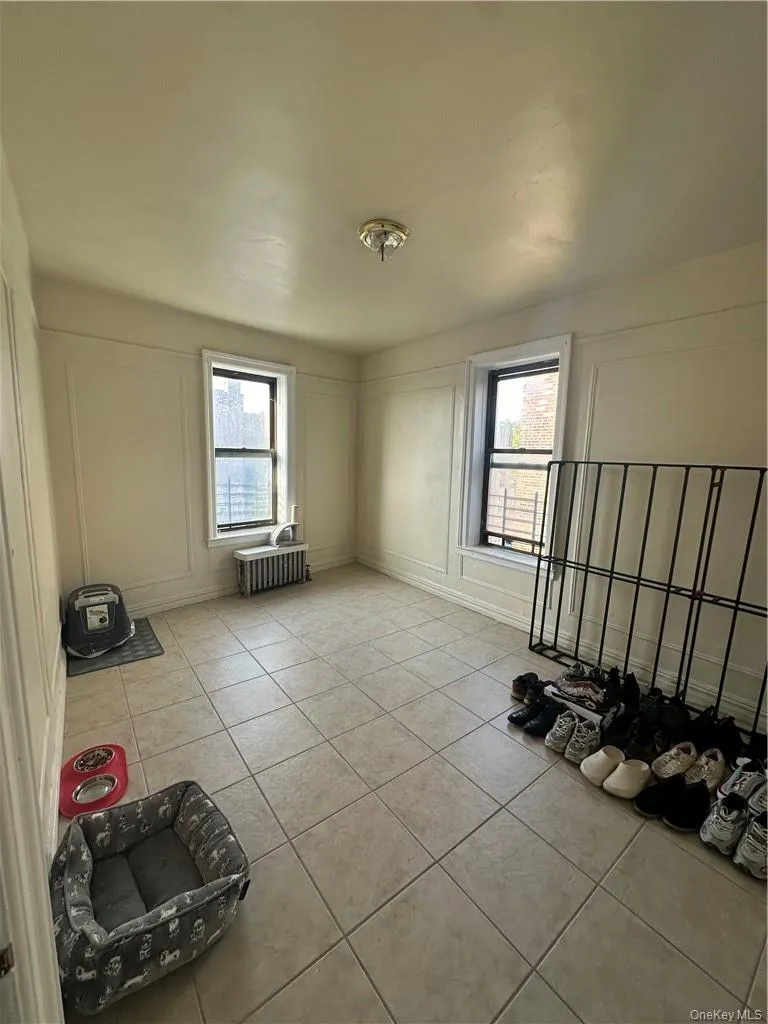 Bedroom featuring light tile floors Bedroom featuring light tile floors