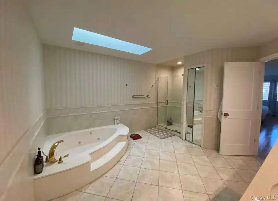 Large bathroom with skylights and double sink. Large bathroom with skylights and double sink.