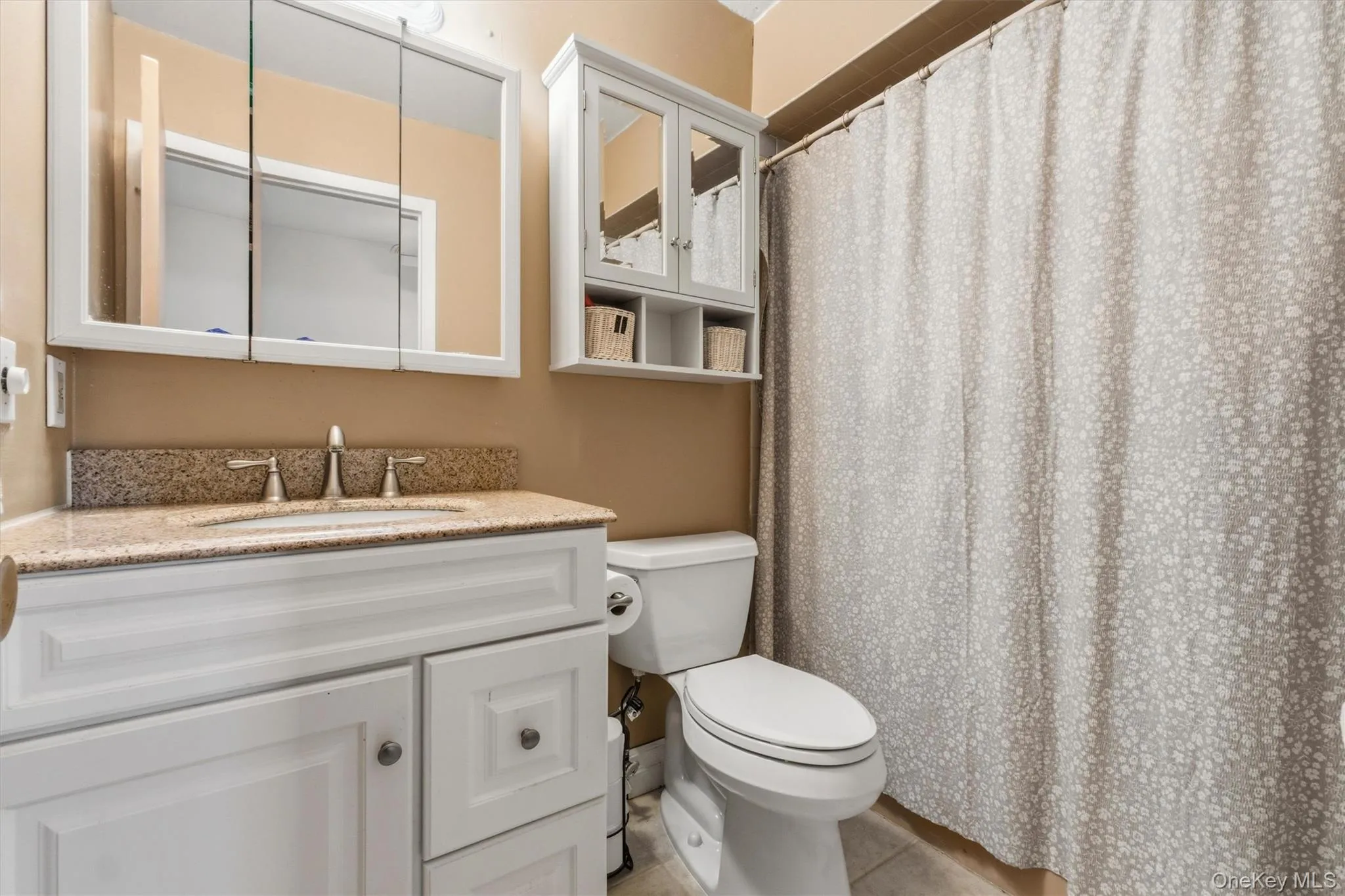 Full hall bath with oversized vanity and tiled floor Full hall bath with oversized vanity and tiled floor
