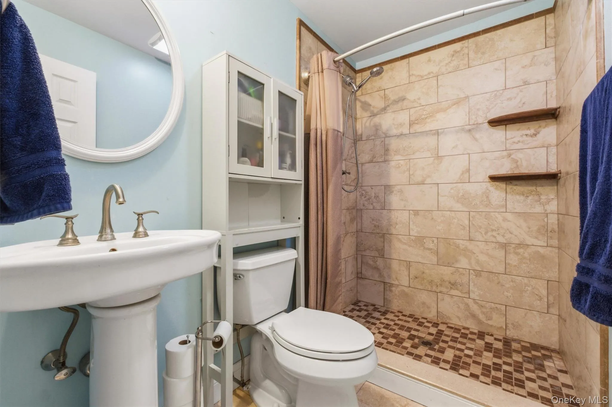 Pedestal sink and tiled walk in shower Pedestal sink and tiled walk in shower