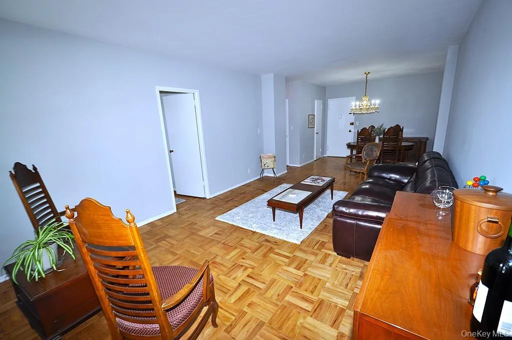 The large living room opens to the dining foyer, has parquet floors and a door to the private balcony. The living room is approx 23'-4" x 11'-2" plus the dining area of an additional 11'3" x 11'-3". The large living room opens to the dining foyer, has parquet floors and a door to the private balcony. The living room is approx 23'-4" x 11'-2" plus the dining area of an additional 11'3" x 11'-3".