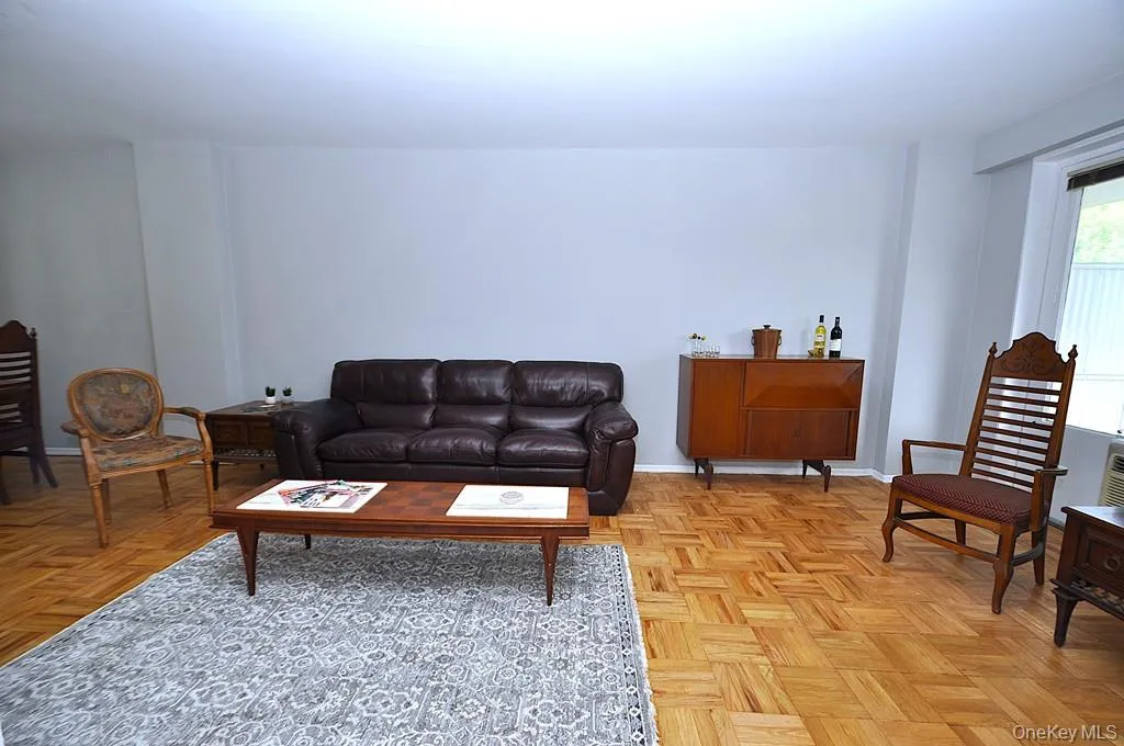 The large living room opens to the dining foyer, has parquet floors and a door to the private balcony. The living room is approx 23'-4" x 11'-2" plus the dining area of an additional 11'3" x 11'-3". The large living room opens to the dining foyer, has parquet floors and a door to the private balcony. The living room is approx 23'-4" x 11'-2" plus the dining area of an additional 11'3" x 11'-3".
