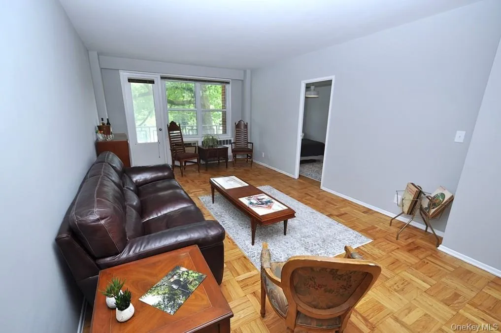 The large living room opens to the dining foyer, has parquet floors and a door to the private balcony. The living room is approx 23'-4" x 11'-2" plus the dining area of an additional 11'3" x 11'-3". The large living room opens to the dining foyer, has parquet floors and a door to the private balcony. The living room is approx 23'-4" x 11'-2" plus the dining area of an additional 11'3" x 11'-3".