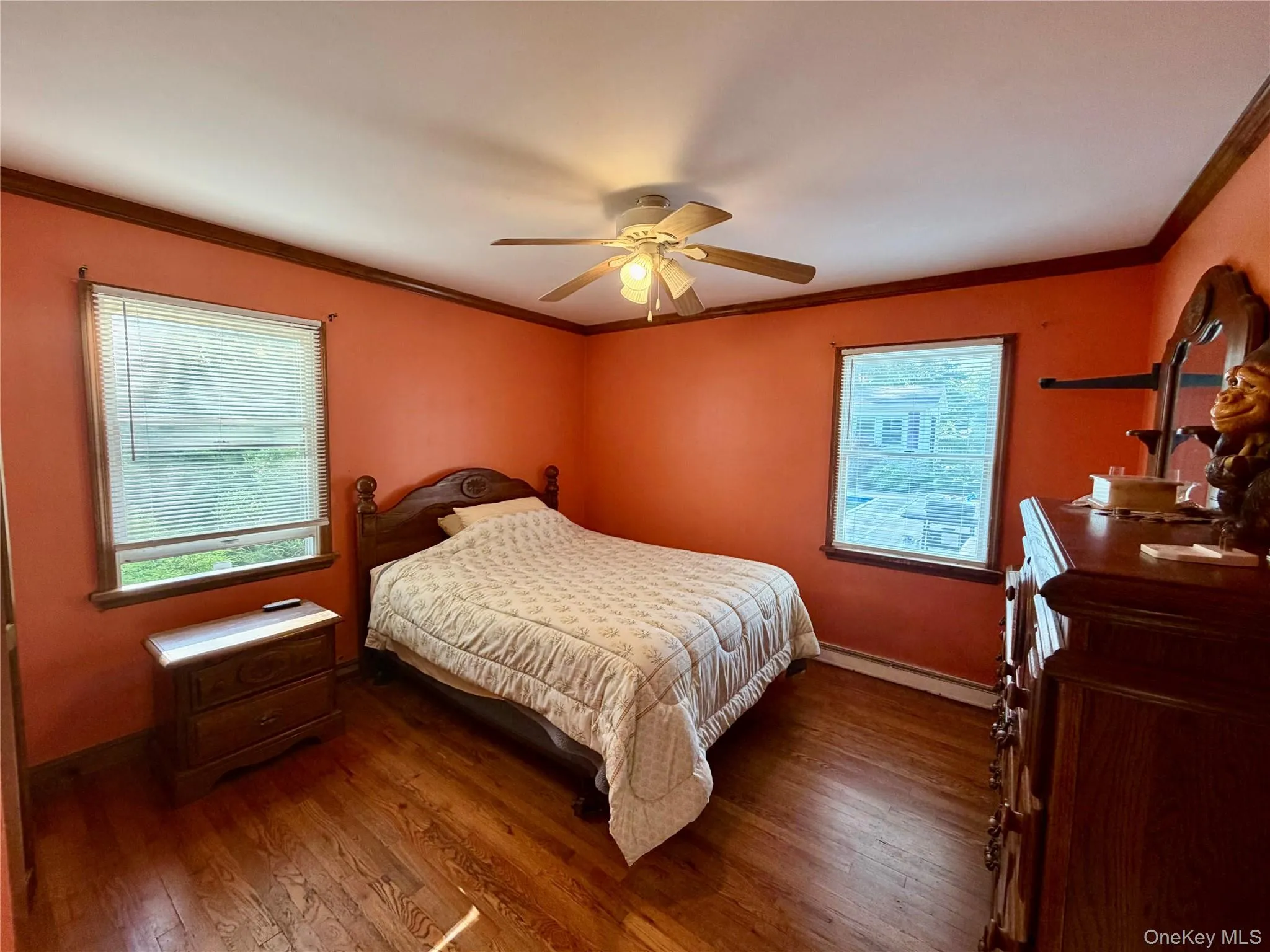 Hardwood flooring, two windows with blinds, ceiling fan with light fixture, and crown molding Hardwood flooring, two windows with blinds, ceiling fan with light fixture, and crown molding