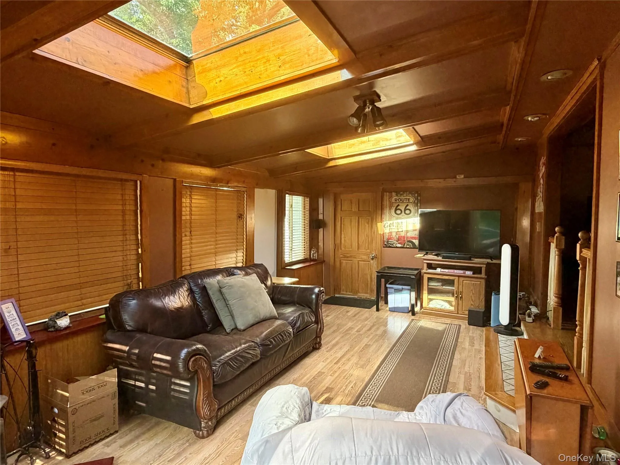 Wood-finish wall paneling, ceiling, and flooring -large skylights Wood-finish wall paneling, ceiling, and flooring -large skylights
