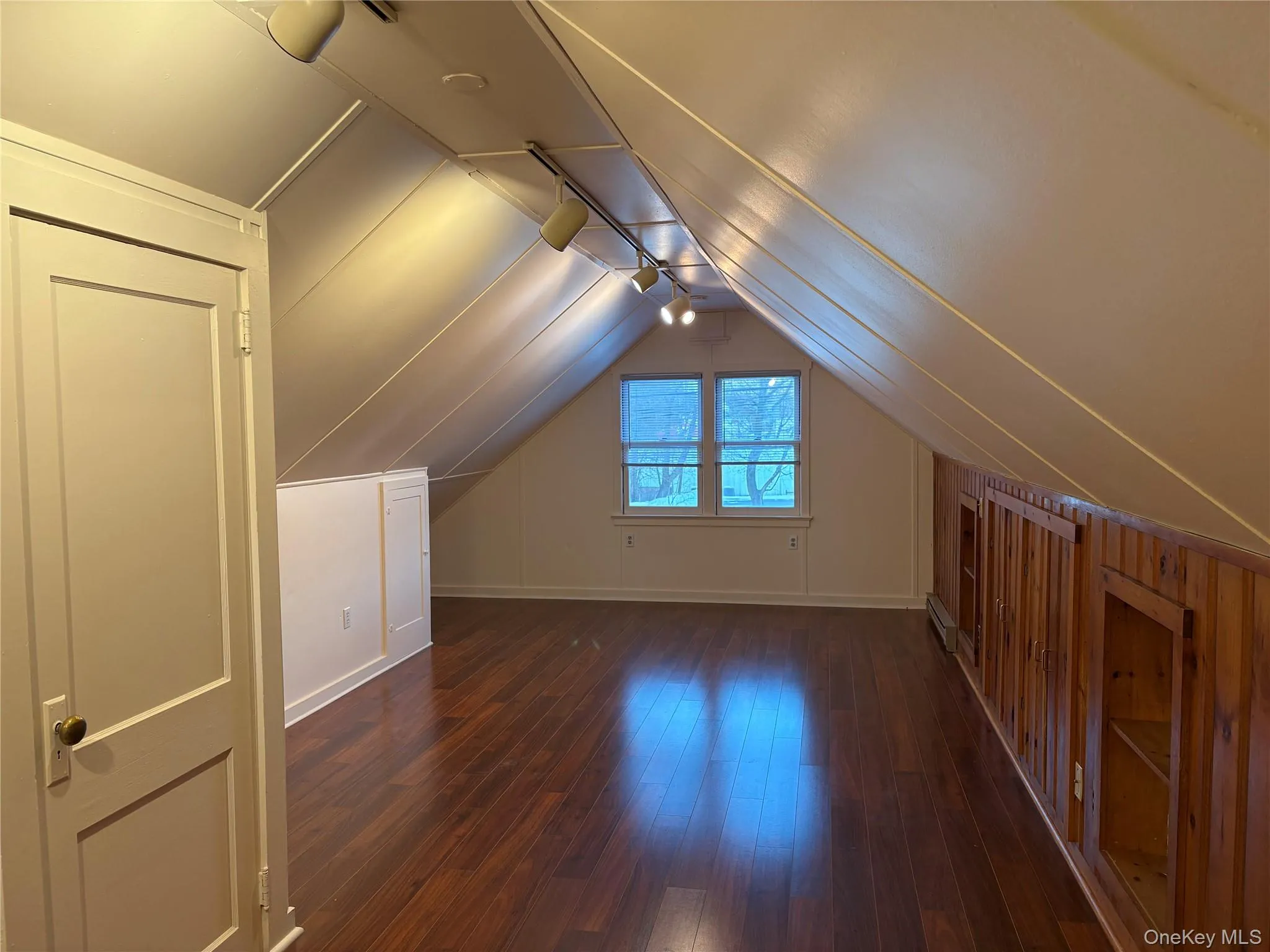 Main room with dark wood-type flooring and lofted ceiling Main room with dark wood-type flooring and lofted ceiling