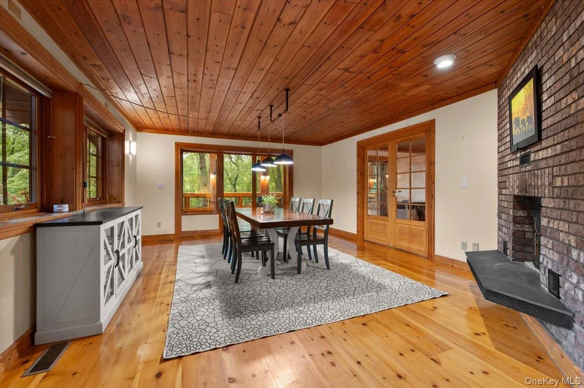 Formal large dining room with its own wood burning fireplace and view toward sunroom. Formal large dining room with its own wood burning fireplace and view toward sunroom.