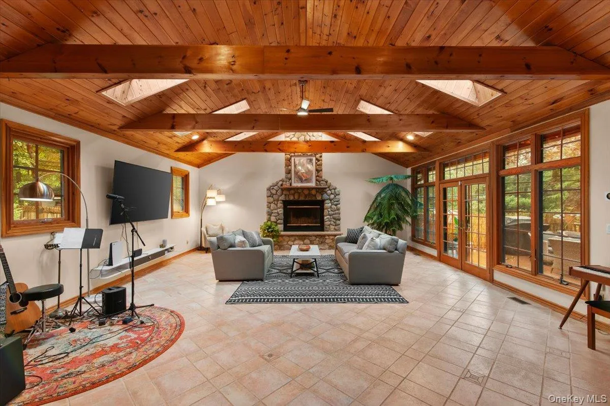 The spacious den features radiant heat floors, cathedral ceilings and skylights. The spacious den features radiant heat floors, cathedral ceilings and skylights.