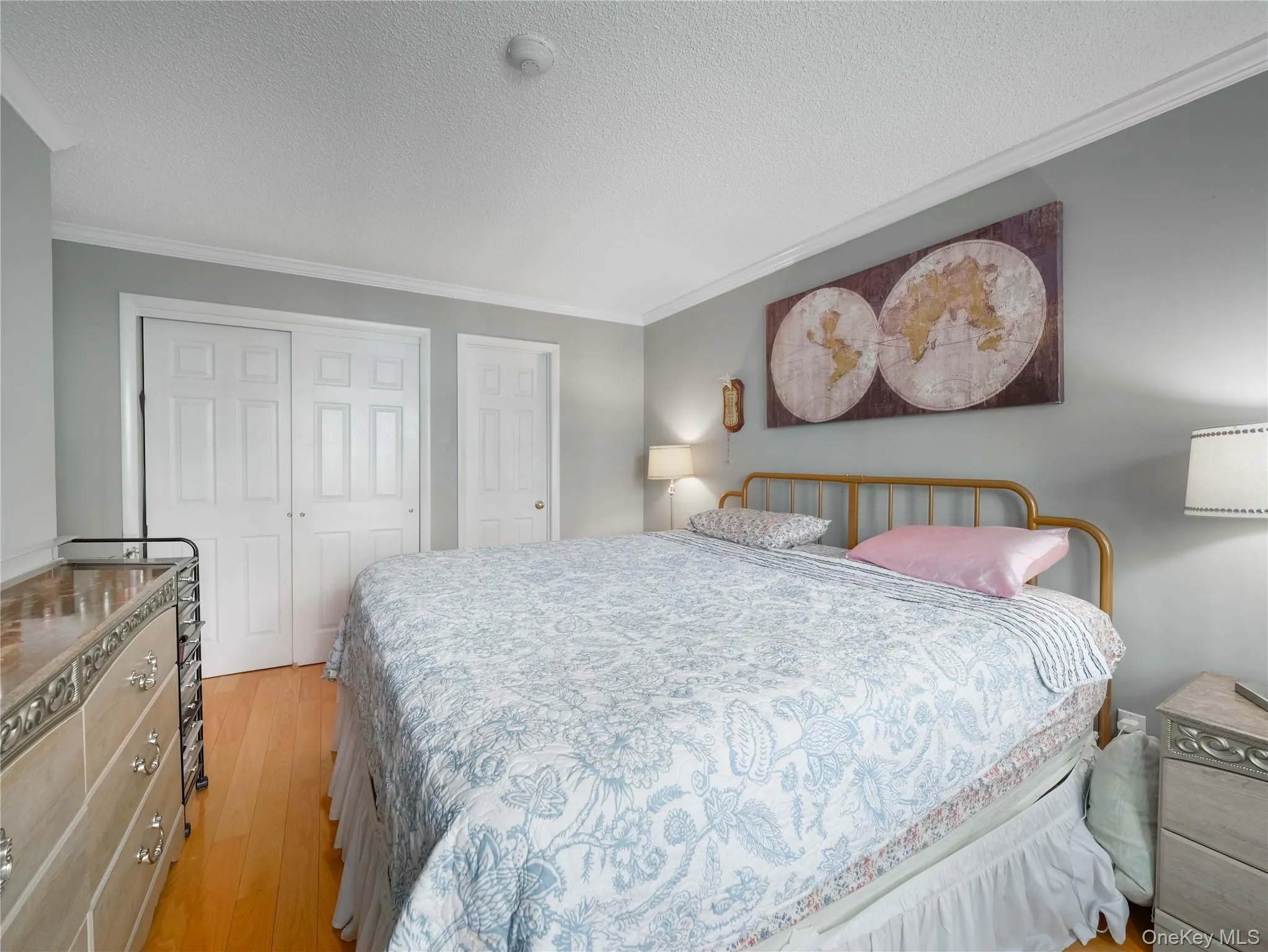 Wood-finish flooring, crown molding, and dual-panel closet doors Wood-finish flooring, crown molding, and dual-panel closet doors