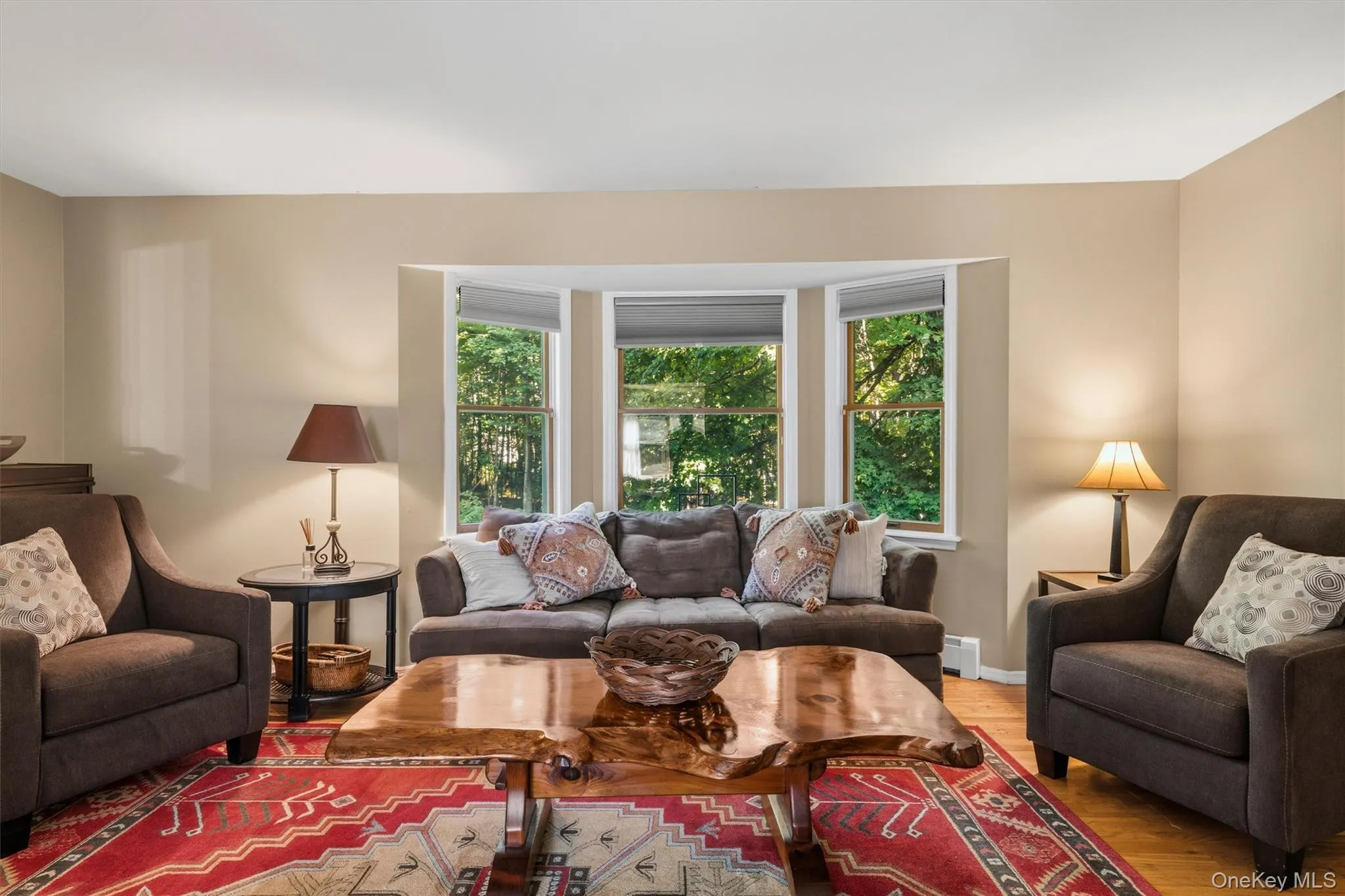 Bay window with multiple panes, light-toned walls, and wood-finish flooring Bay window with multiple panes, light-toned walls, and wood-finish flooring