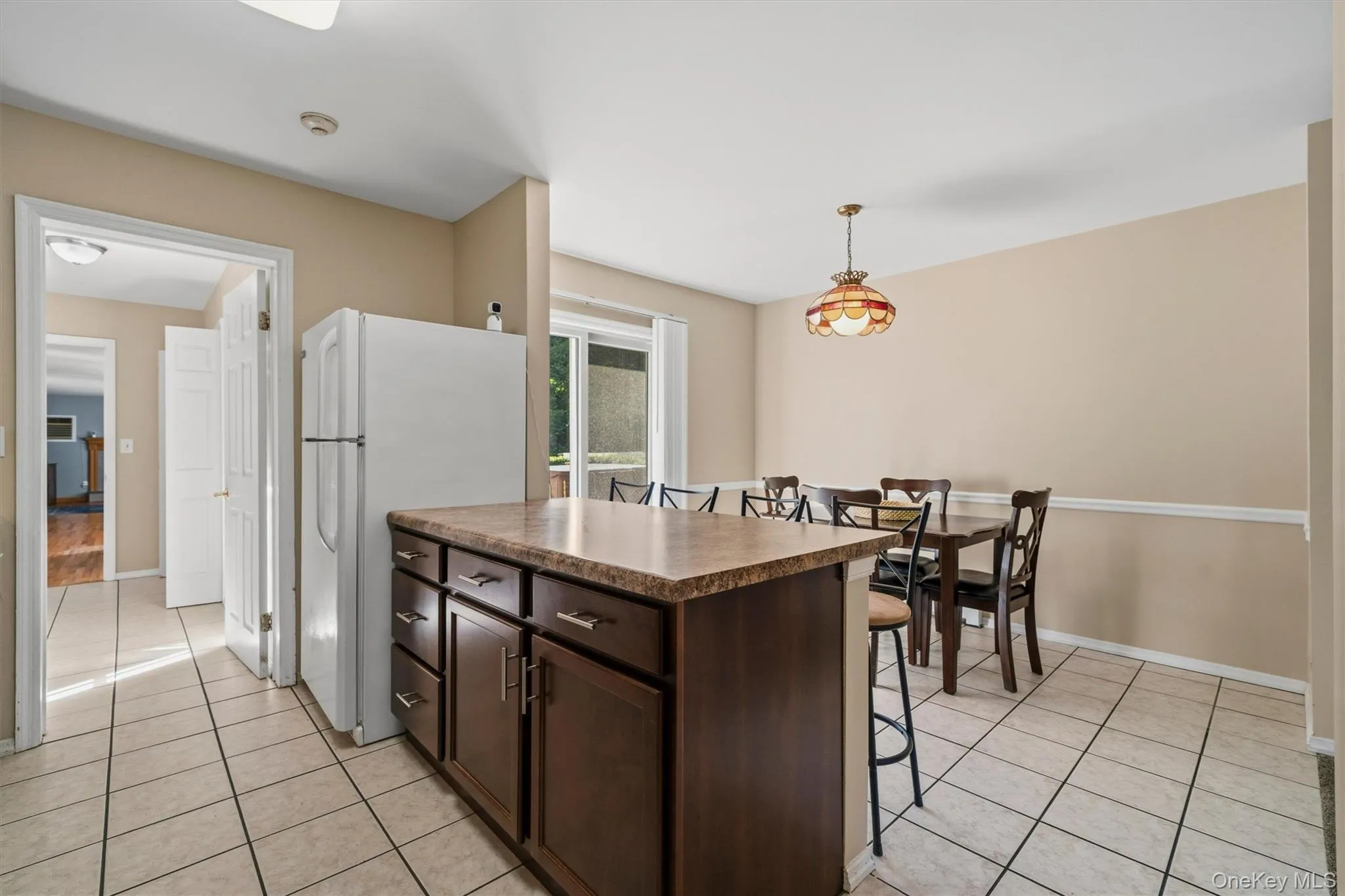 Mother/daughter Kitchen island with dark wood-finish cabinetry and a stone-finish countertop Mother/daughter Kitchen island with dark wood-finish cabinetry and a stone-finish countertop