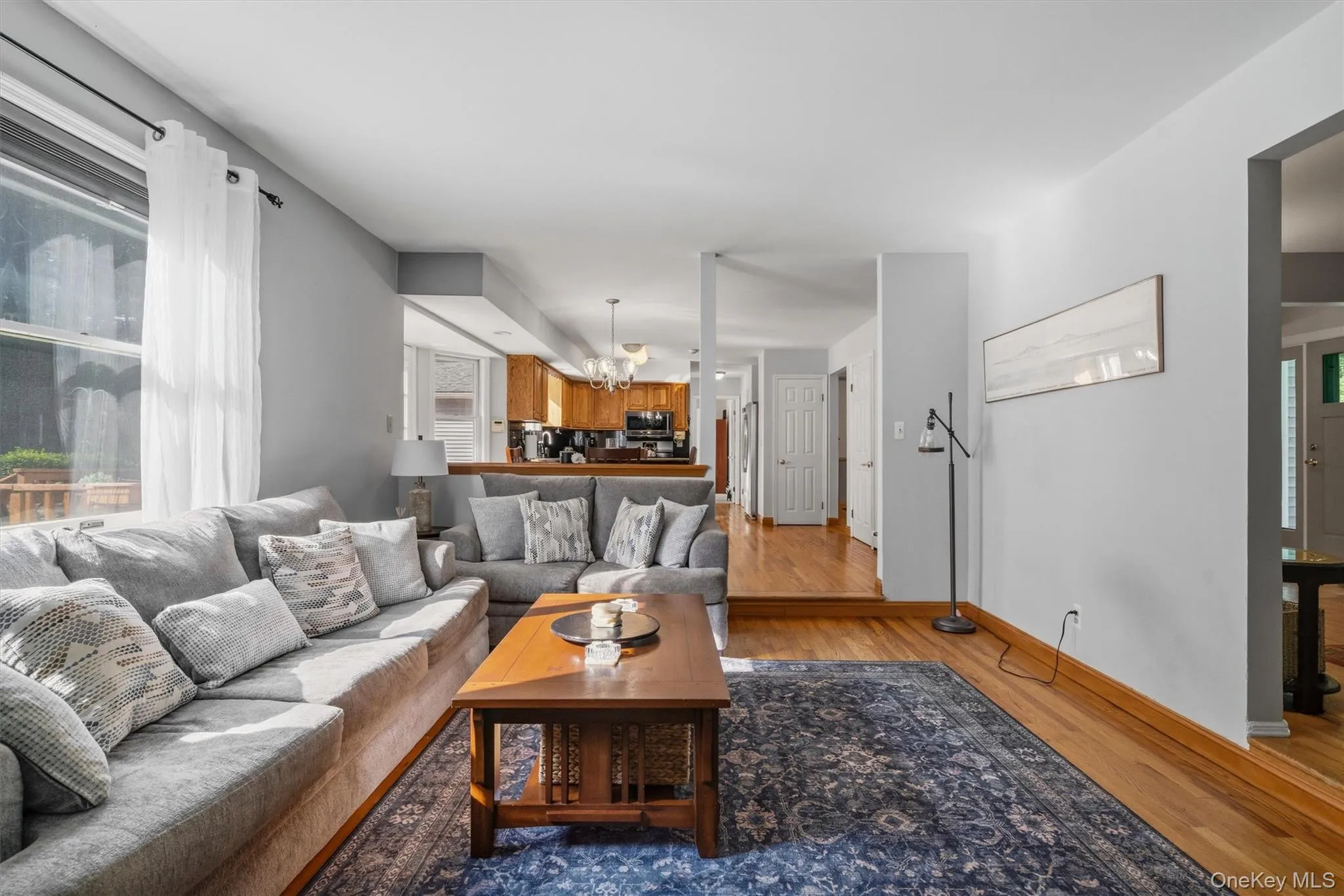Wood-finish flooring throughout, light gray wall tones, and recessed lighting Wood-finish flooring throughout, light gray wall tones, and recessed lighting