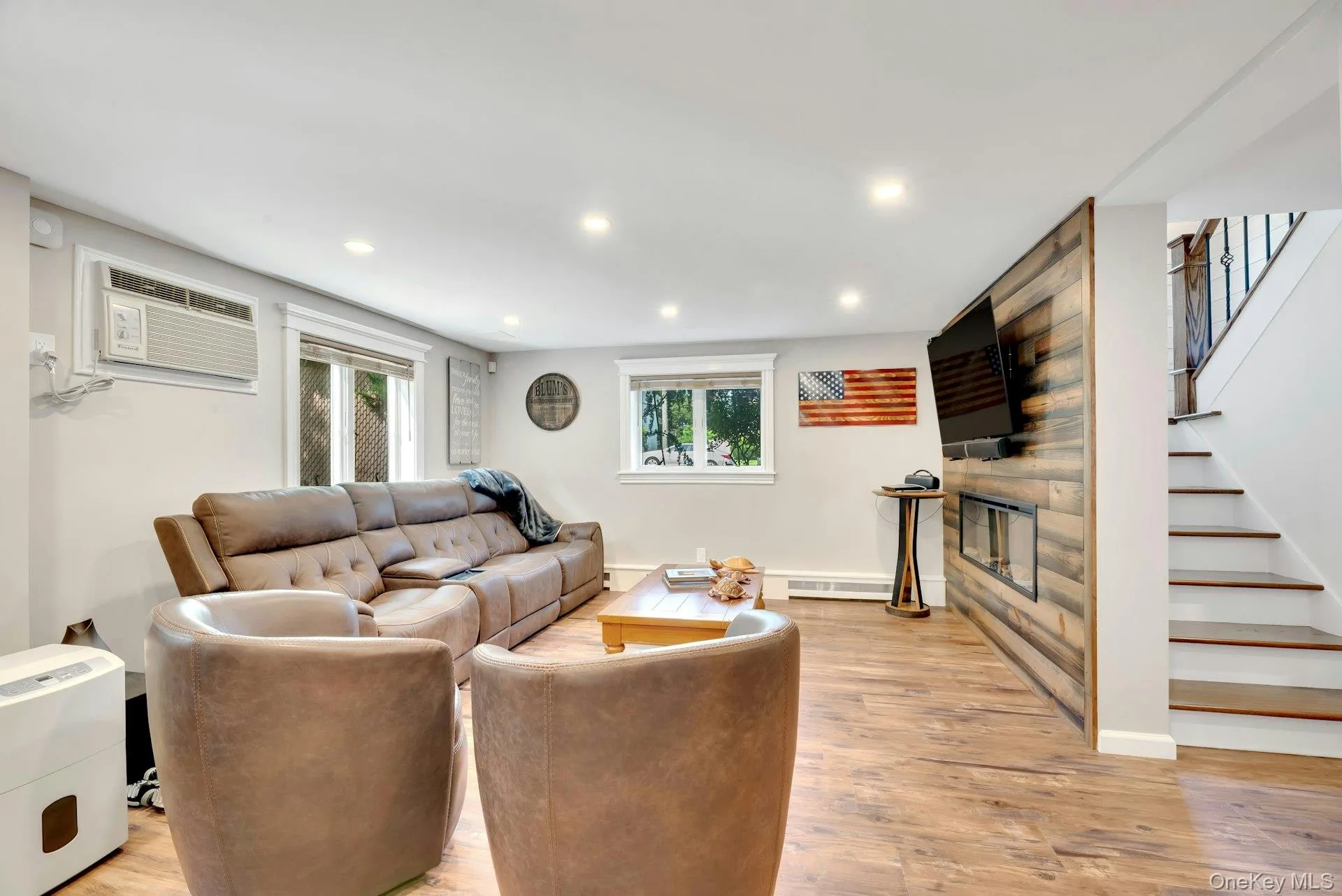 Lower Level family room with accent wall and integrated electric fire place. Lower Level family room with accent wall and integrated electric fire place.