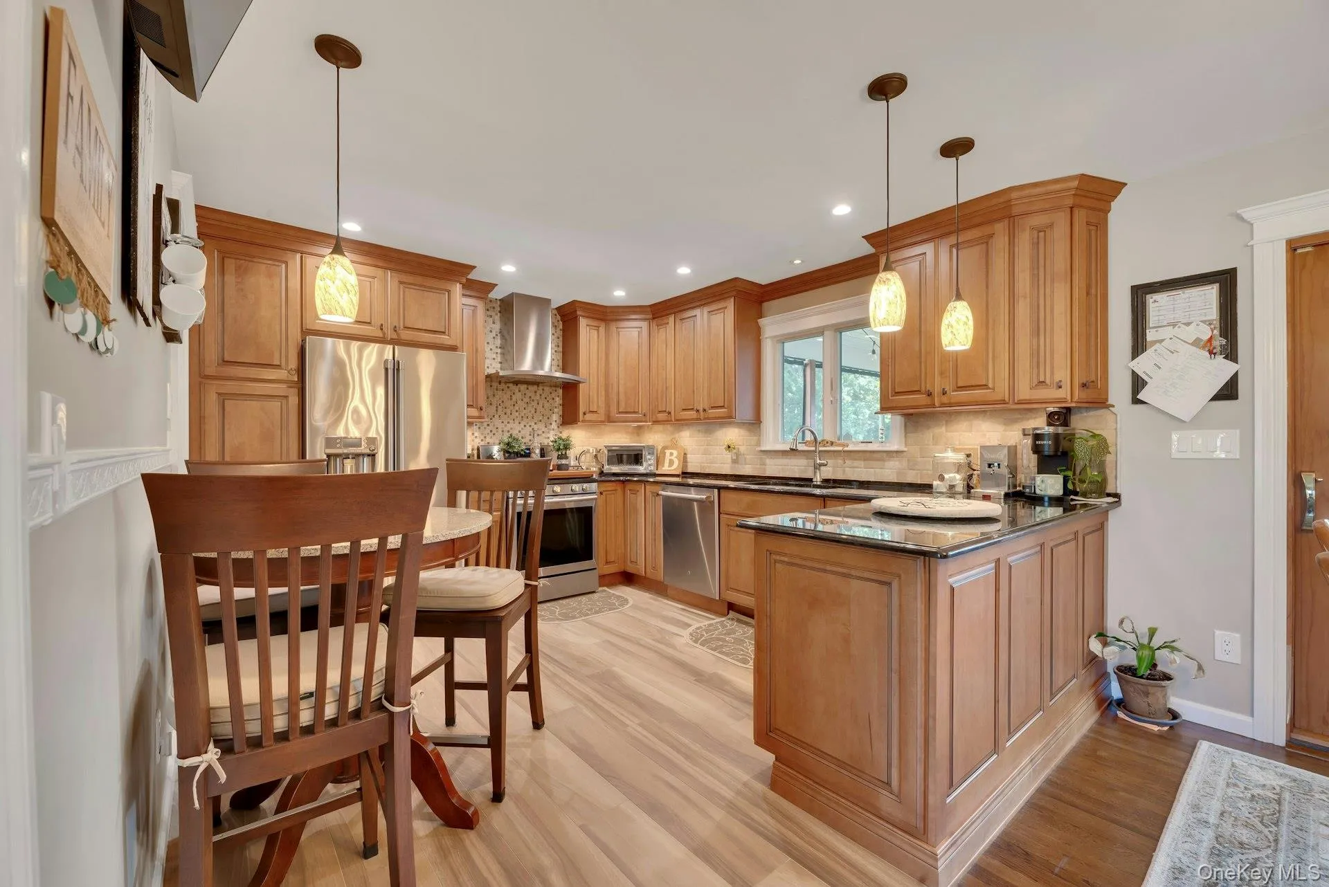 Eat-In-Kitchen featuring custom cabinetry, stainless steel appliances, gas range, pendant lighting, recessed lighting Eat-In-Kitchen featuring custom cabinetry, stainless steel appliances, gas range, pendant lighting, recessed lighting